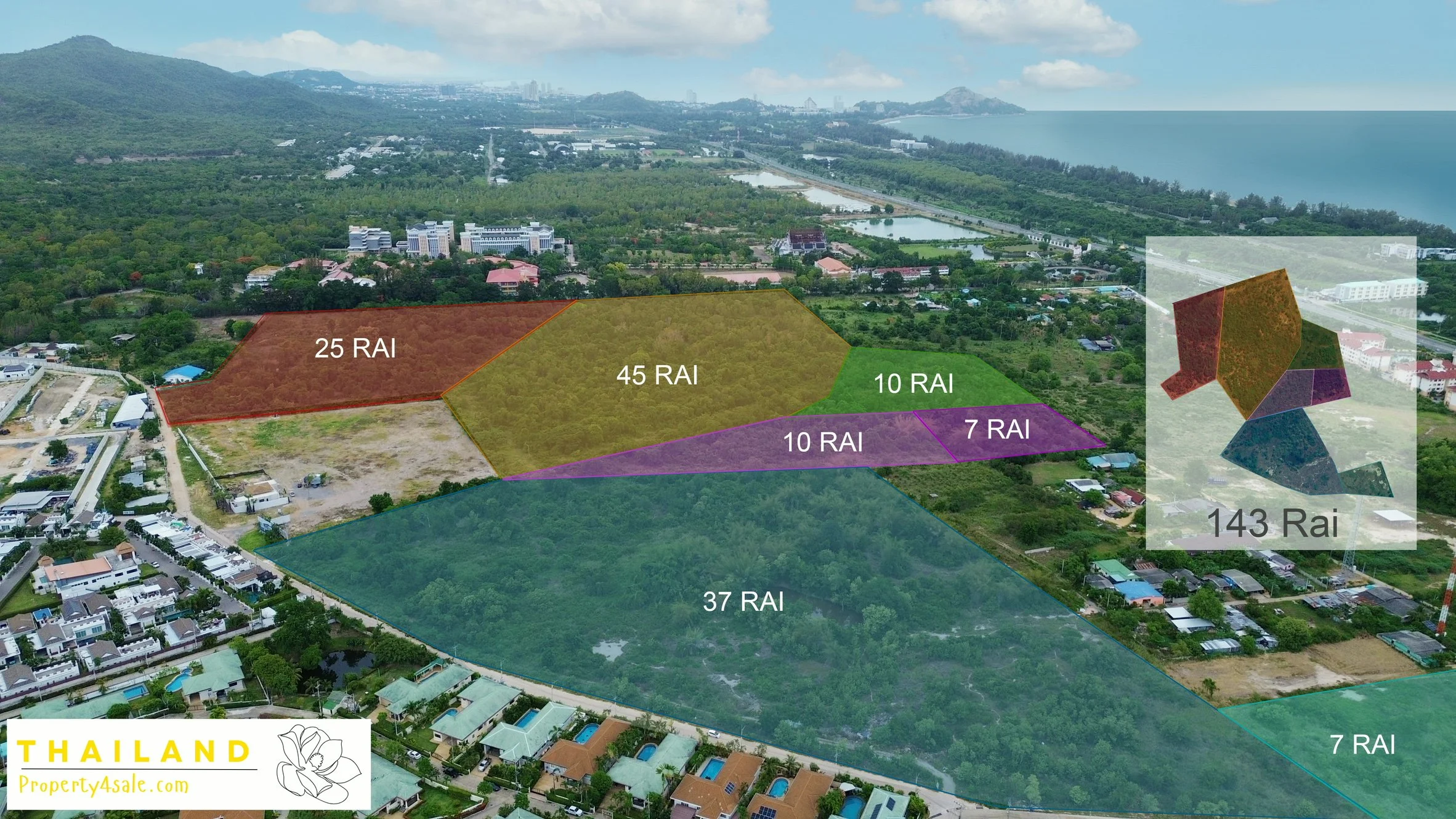 Aerial view of green landscape with houses, roads, and distant mountains and coast.