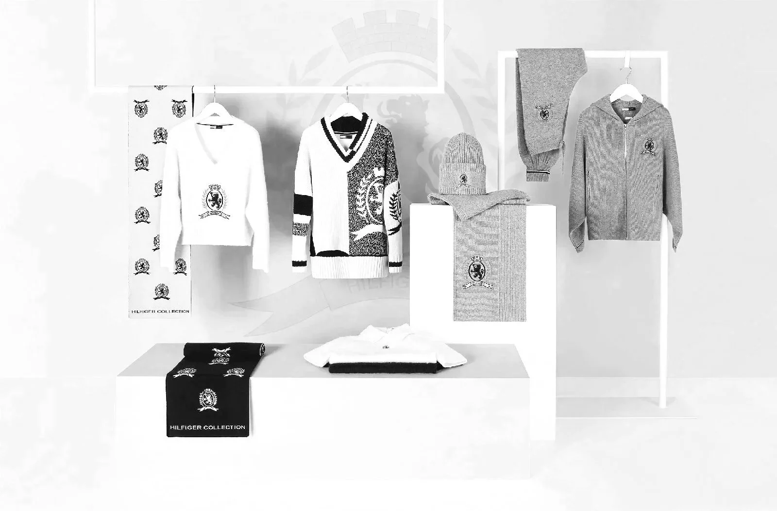 Display of clothing range including sweaters, scarves, and hats with the branding logo.