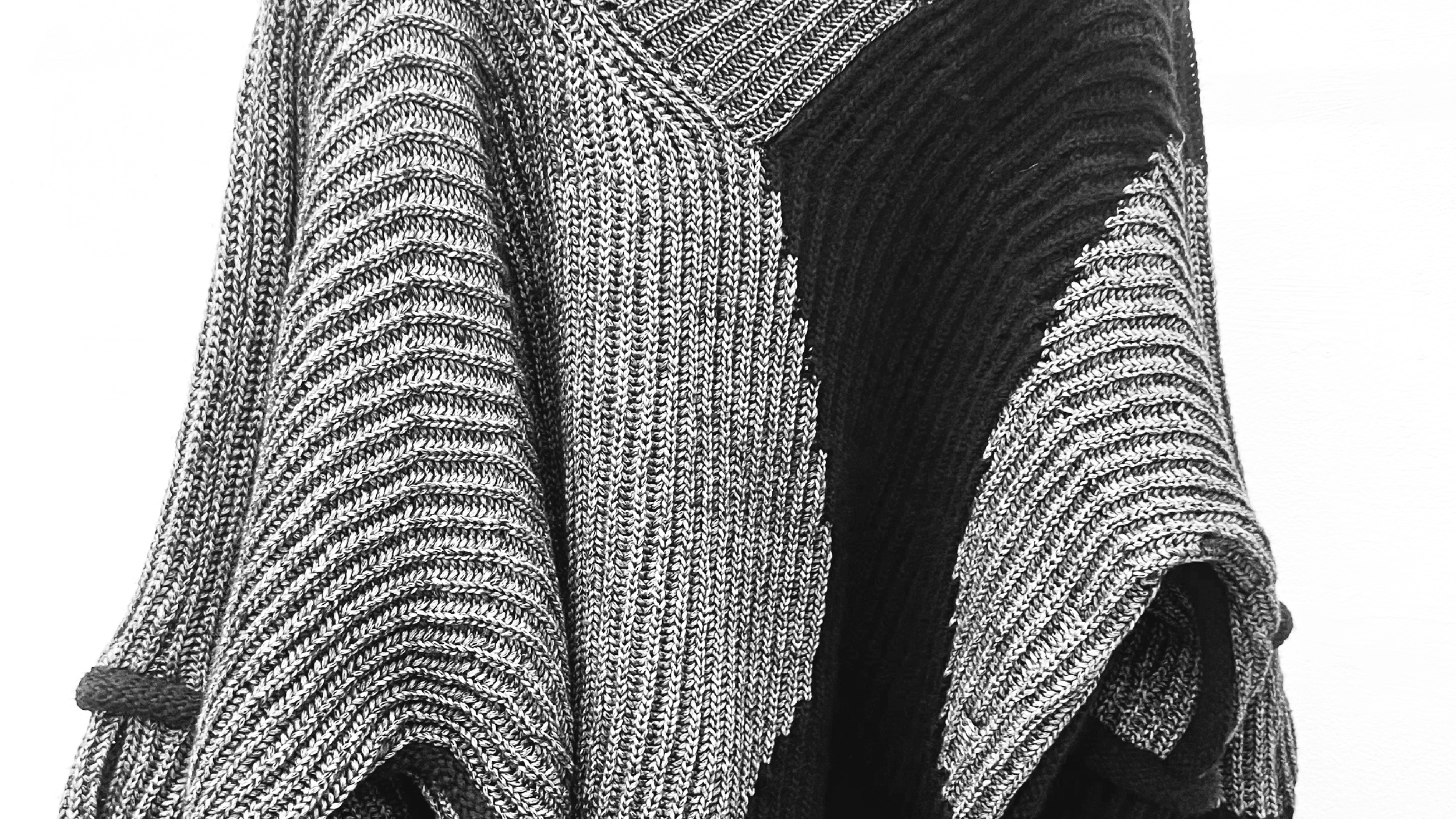 Close-up of a sweater with knitted goring pattern.