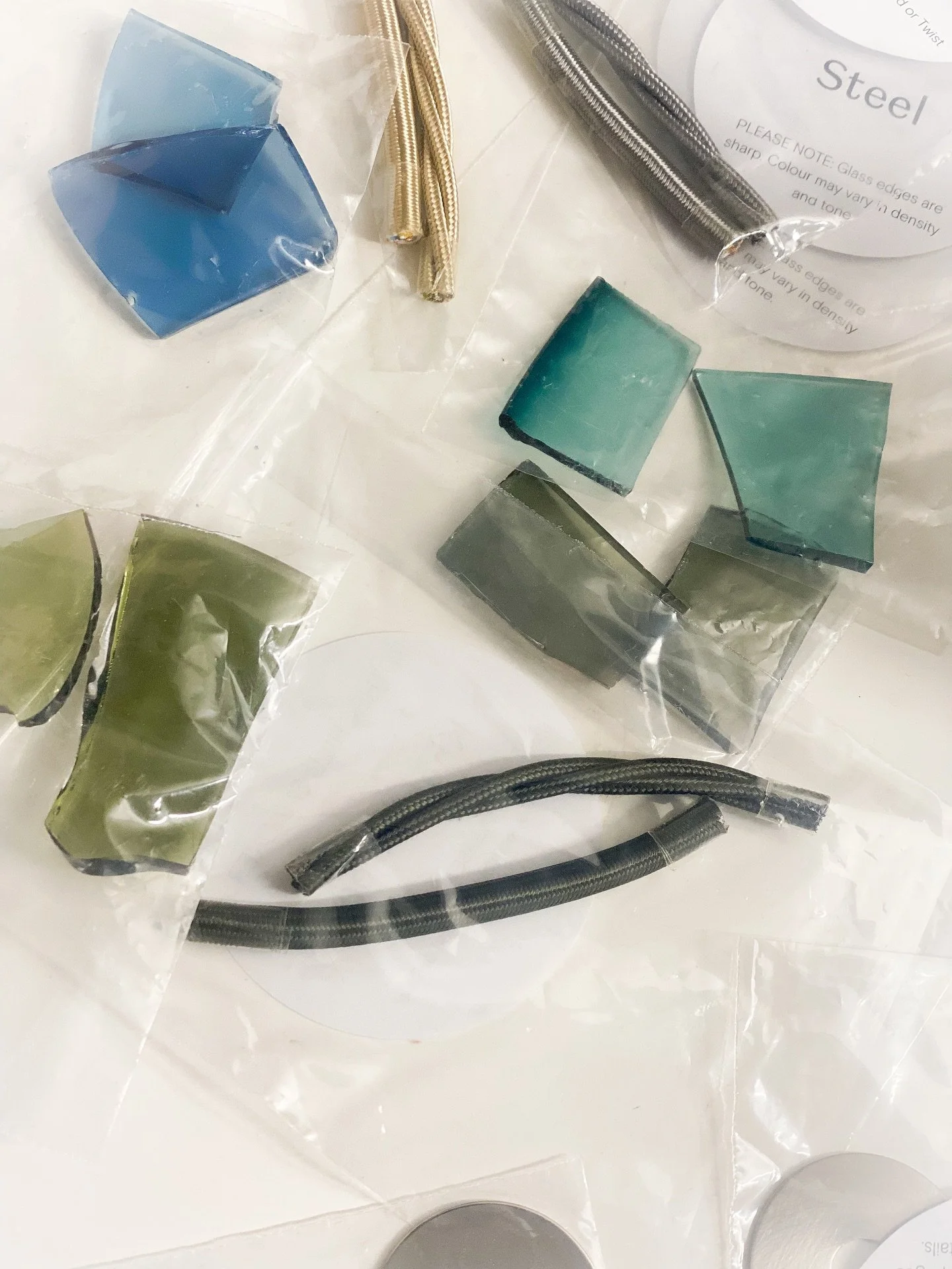 Currently overthinking shades of blue and green glass (and flex cables) 🩵 The most delicate, stunning, mildly dangerous samples currently living on my desk - thanks @rothschildbickers 🤍