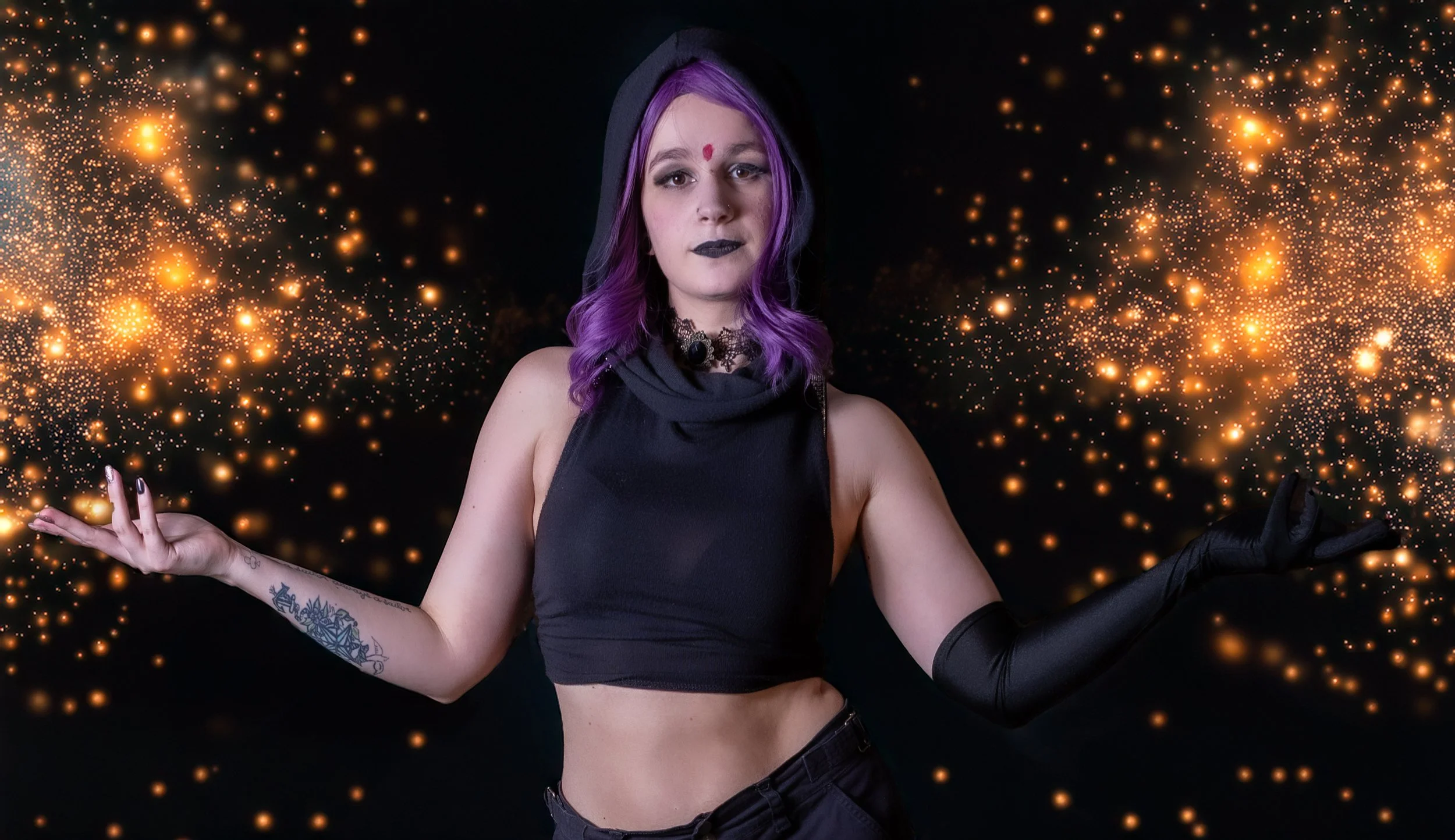 A young woman with purple hair and dark makeup wearing a black sleeveless crop top, black gloves, and a choker, standing against a black background with orange glittering light effects.
