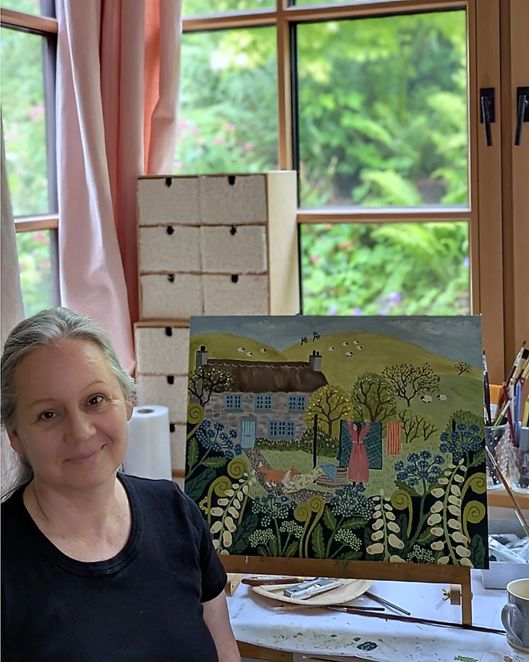 Artist Birgit Hämmerle in her studio in front of one of her oil paintings.