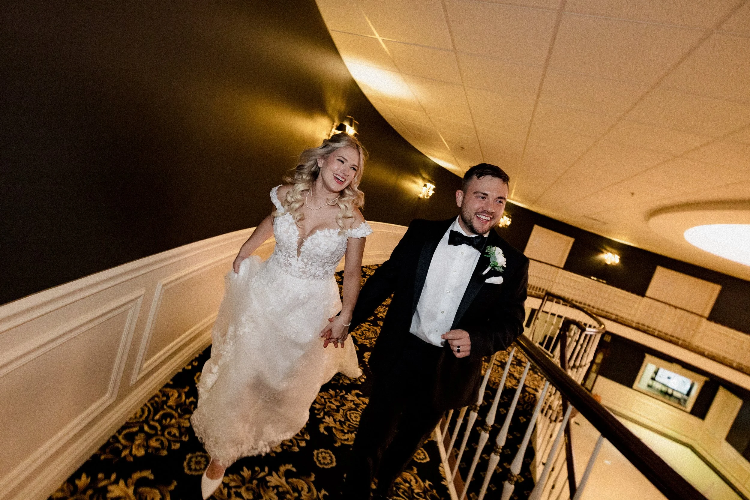 Bride and groom happily running down an aisle