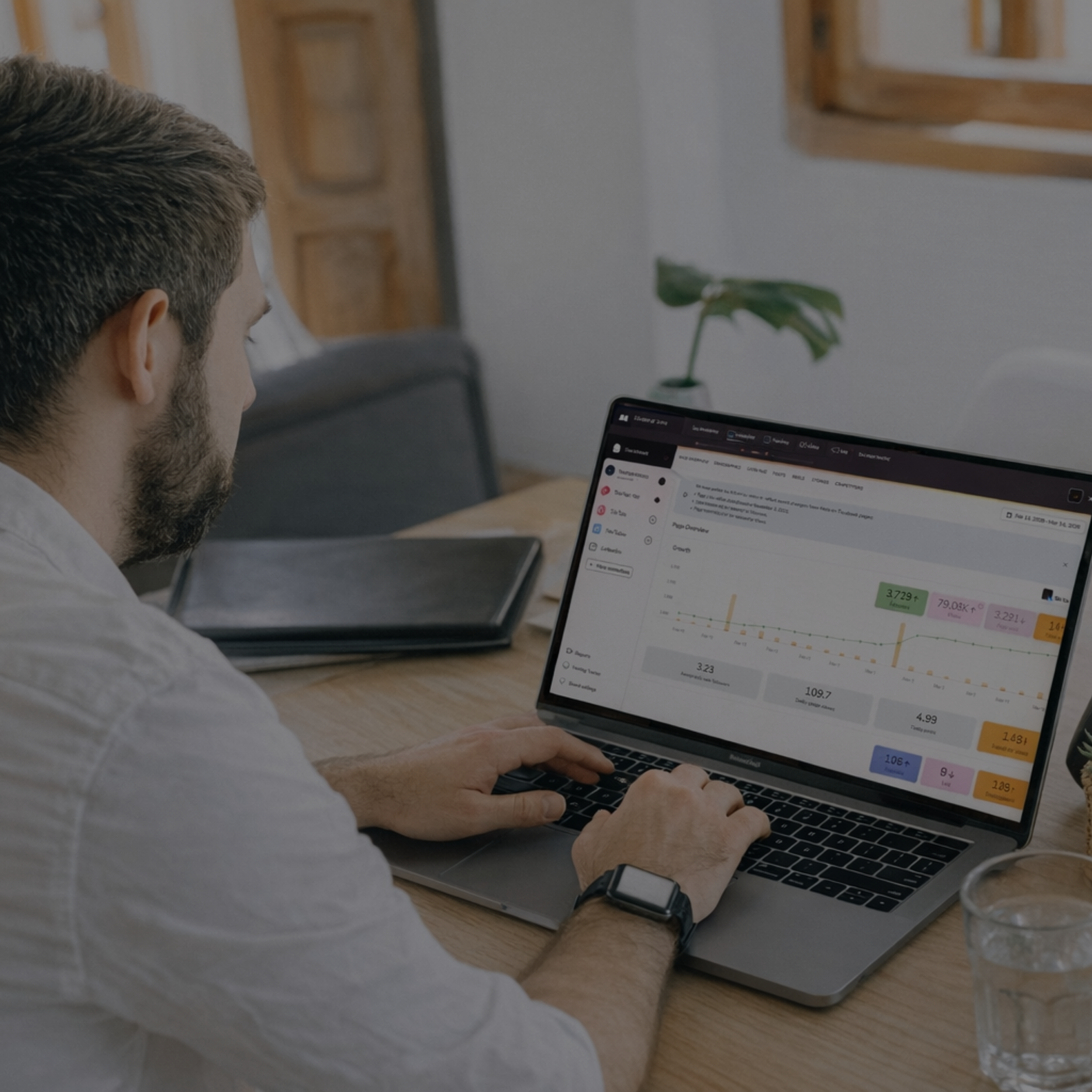 Entrepreneur working at a laptop with a digital marketing dashboard on screen, representing the done-for-you social media and email marketing services offered by Click Command Co.