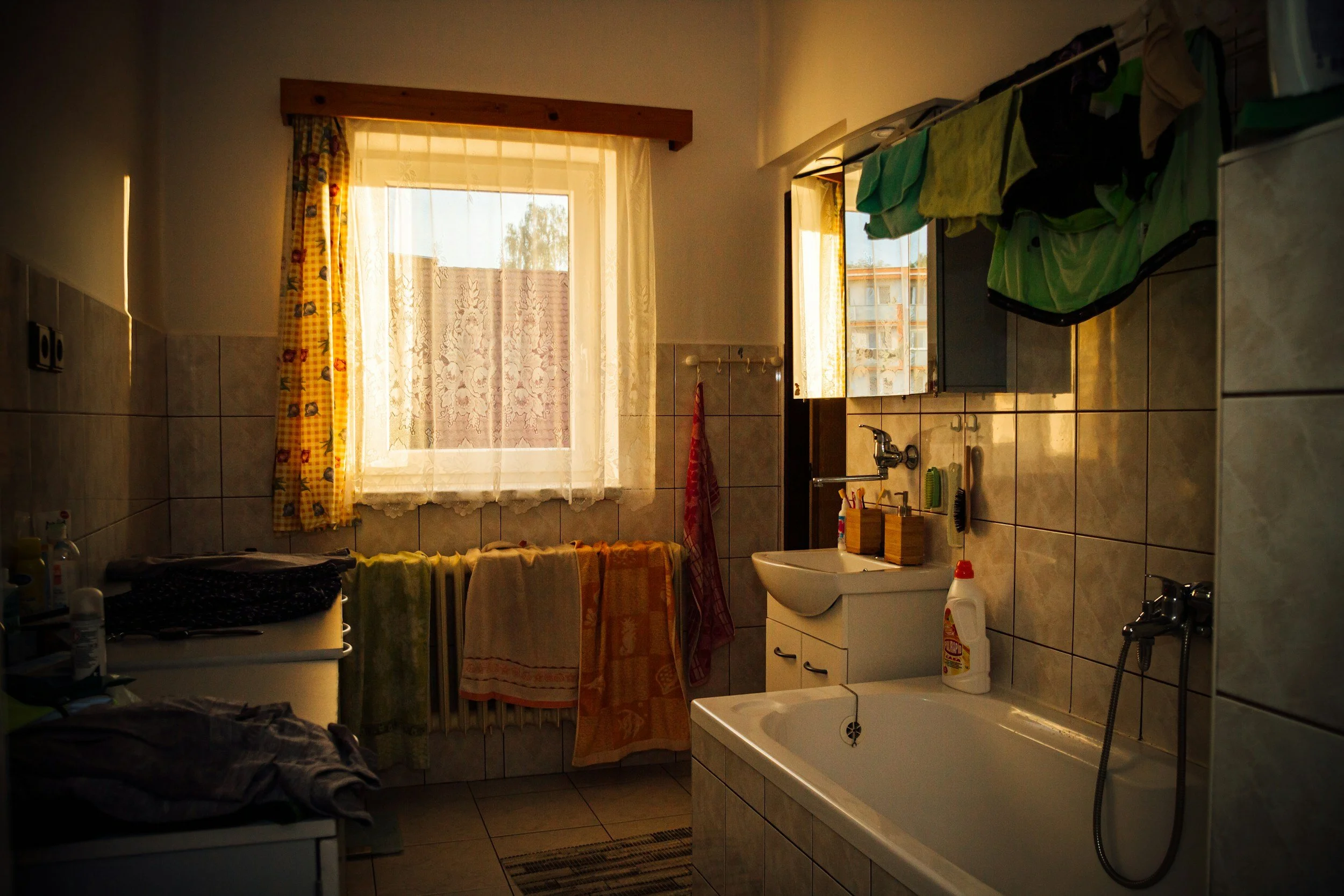 A standard household bathroom with towels on the radiator, representing a high-traffic area that needs regular cleaning.