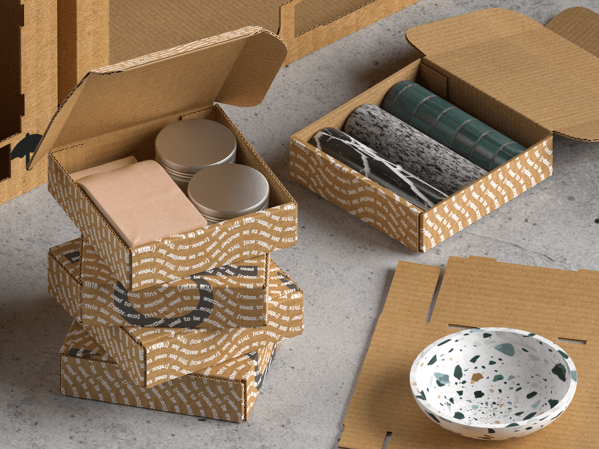 Open cardboard boxes containing ceramic bowls, tins, and rolled-up papers or fabrics, placed on a concrete surface with additional cardboard boxes and a terrazzo bowl nearby.
