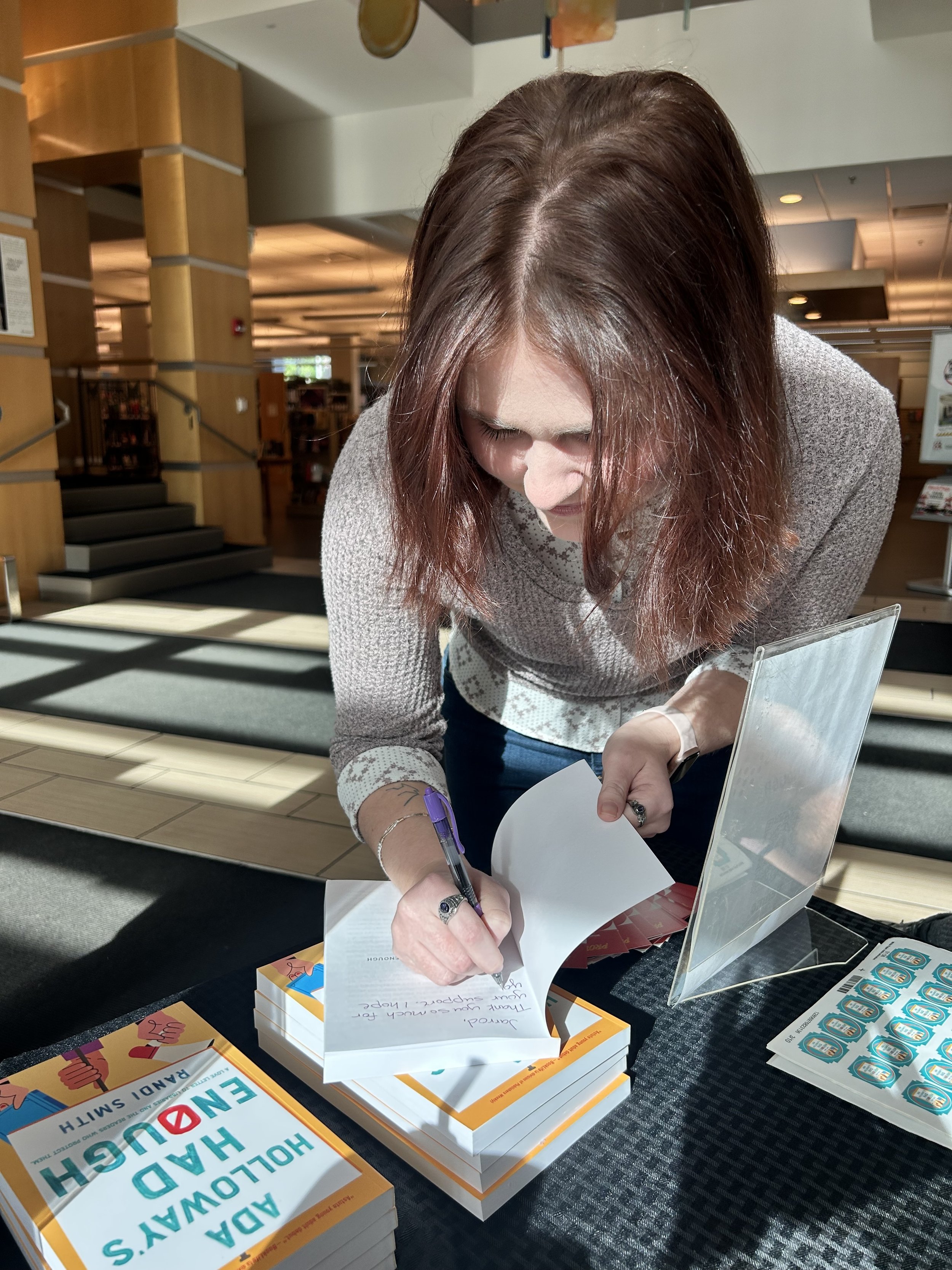 Randi Smith signs a copy of her book