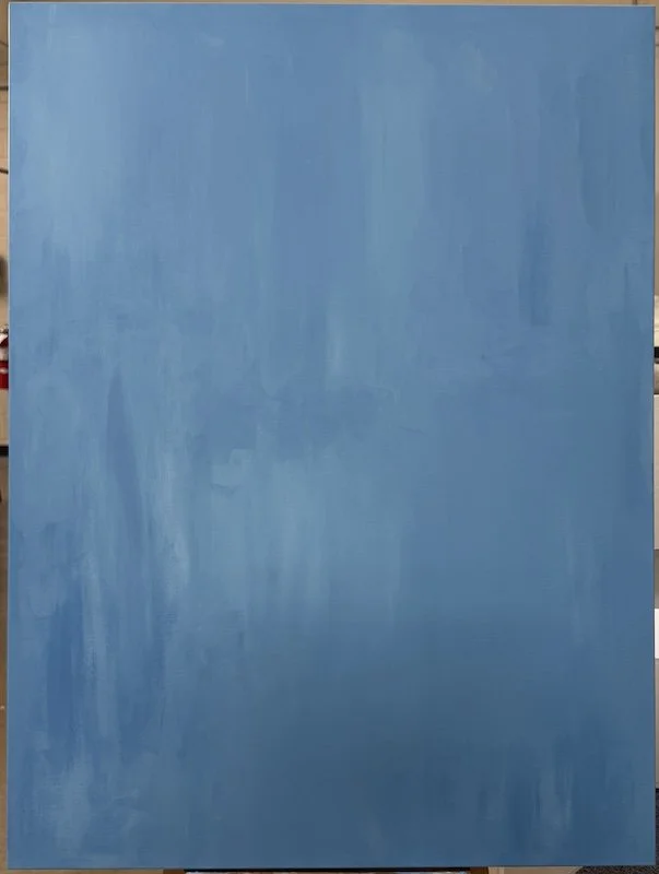 A large, abstract blue painting with varying shades and textured brushstrokes, mounted on a wall.