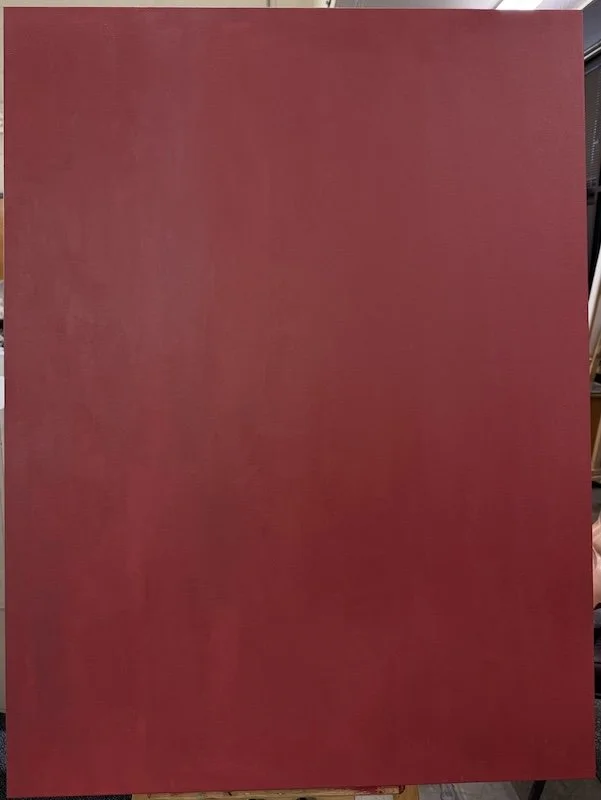 Solid red rectangular canvas or board leaning against a surface.