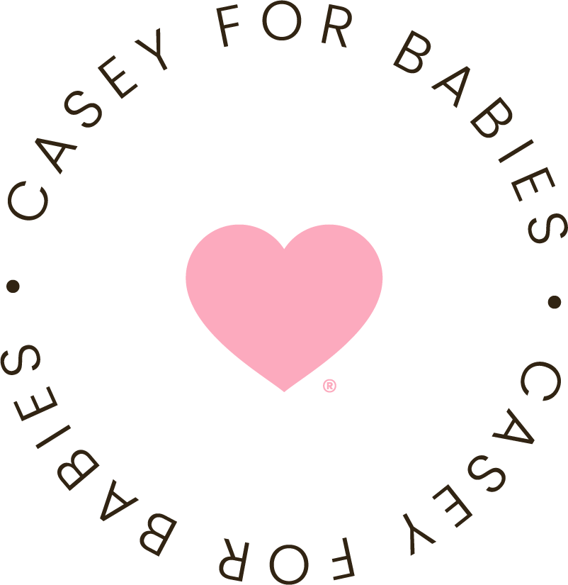 Logo with a pink heart in the center surrounded by the words "CASEY FOR BABIES. CASEY FOR BABIES." in circular arrangement.