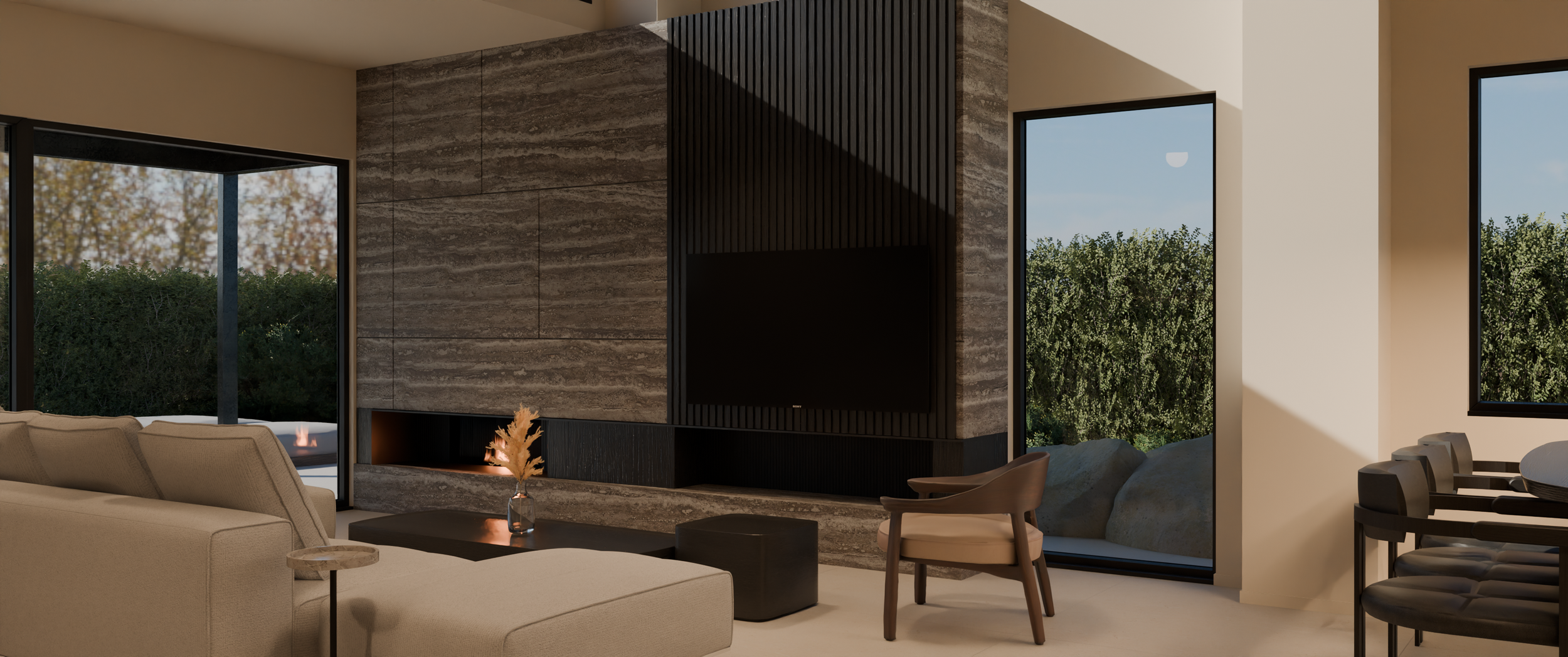 Modern living room with beige sectional sofa, black coffee table, and armchair, featuring a large flat-screen TV on a textured stone wall, large windows showing outdoor greenery, and a dining area with black chairs.