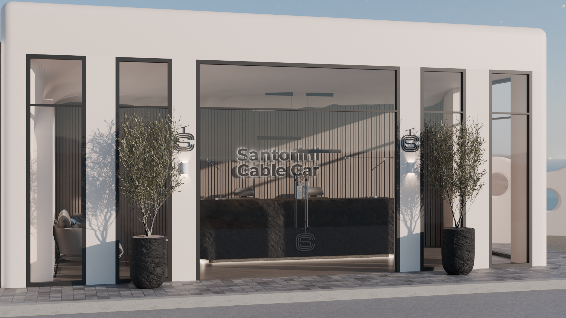 Modern building entrance with white walls, black framed glass doors, potted trees on either side, and a reception desk visible through the glass with the sign 'Santorini Cable Car' behind it.