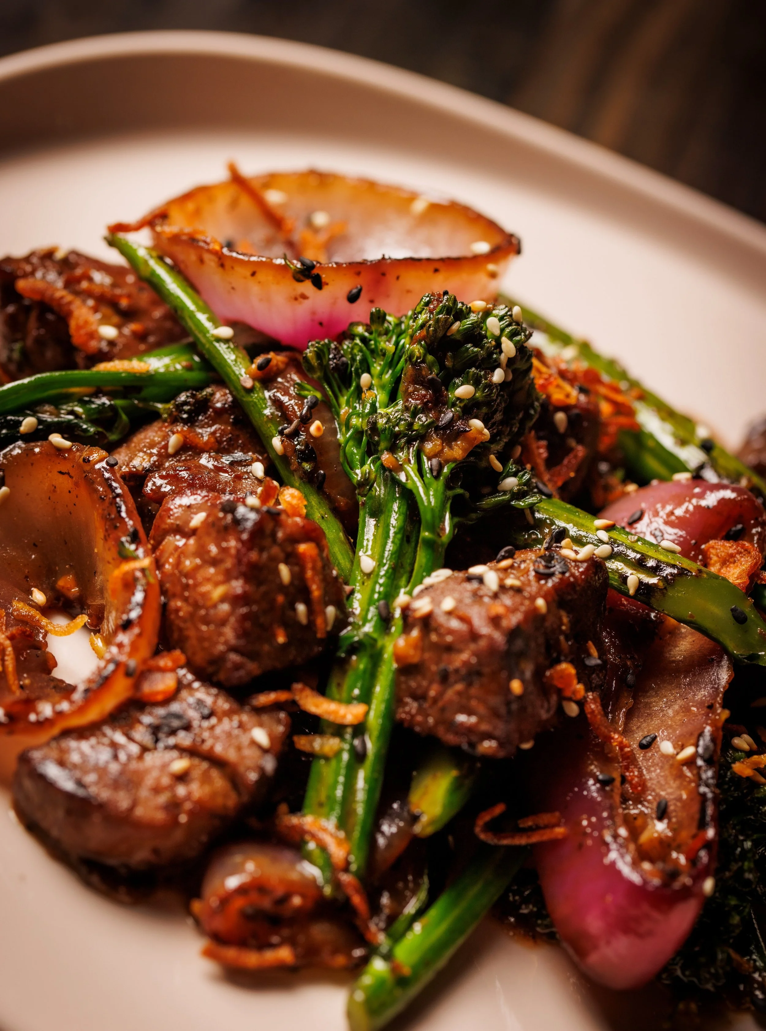 Tender Prime Bavette meets perfectly wok-charred broccolini in a bold black pepper sauce at Night Rooster in The Design District. This isn't your average beef &amp; broccoli &mdash; it's elevated, juicy, and packed with flavor from Chef Shirley Chung