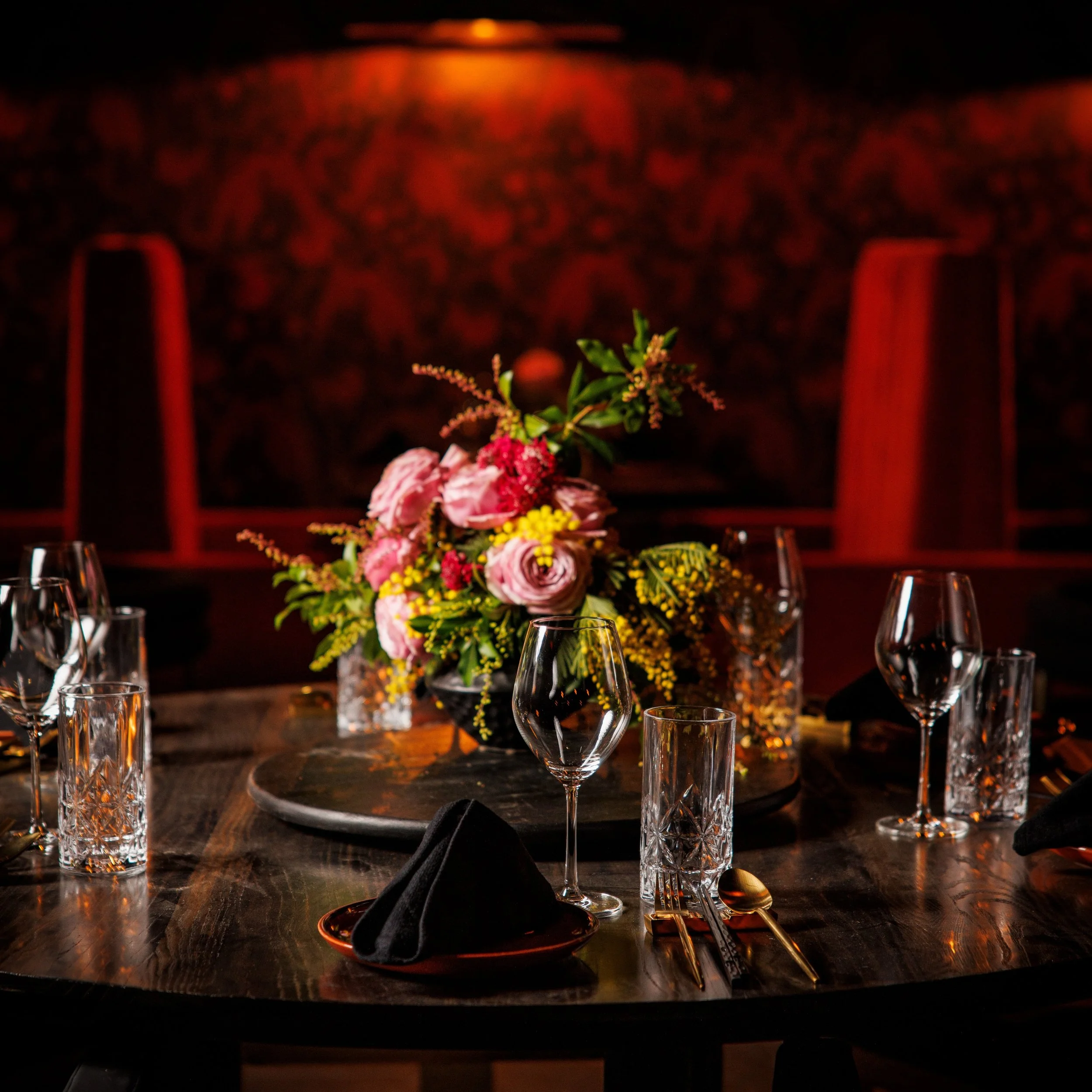 Dim lights, red accents, and a ceiling that blooms like midnight fireworks. Night Rooster&rsquo;s dining room isn&rsquo;t just where you eat &mdash; it&rsquo;s where the night gets interesting.