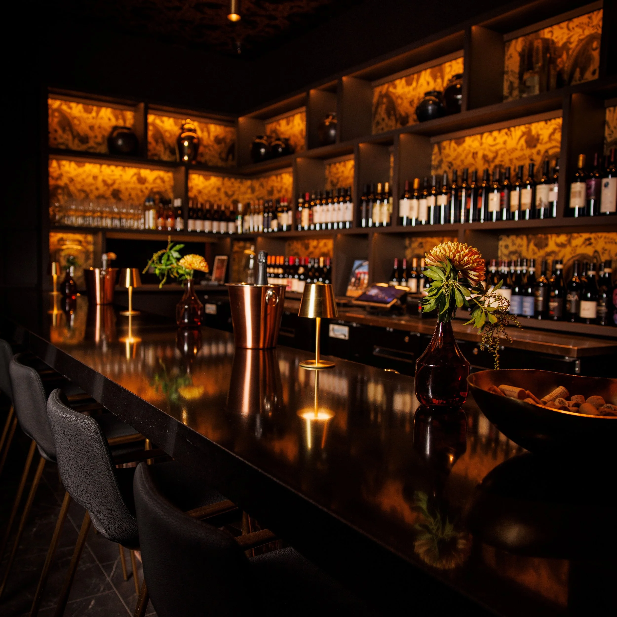 Midnight gold at the Night Rooster bar. Copper glows against black, and every seat feels like a private speakeasy moment. Come settle in for a cocktail (or a glass of something special) under the patterned ceiling and let the night unfold.

Happy Hou