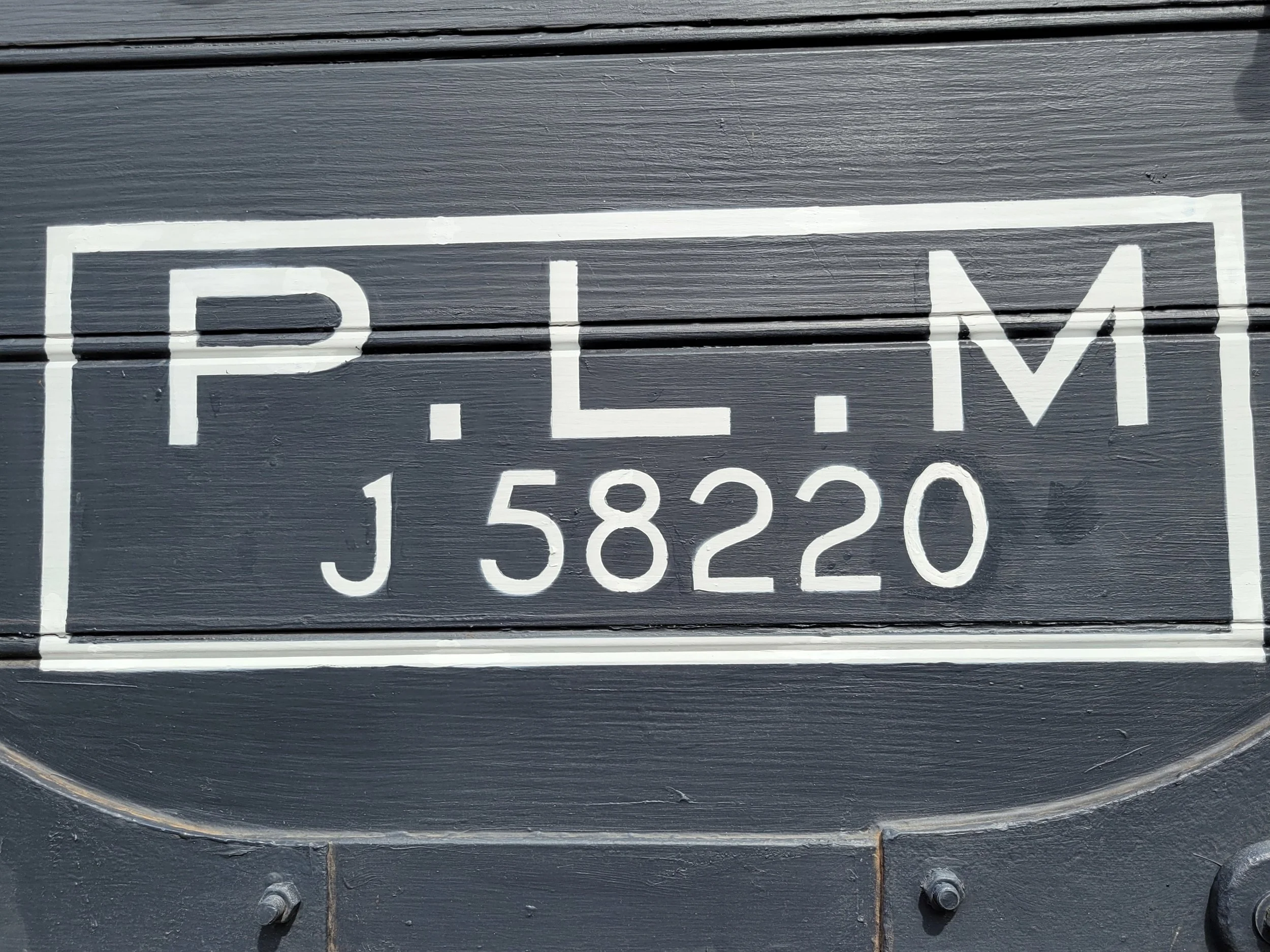 The company that originally owned the boxcar: Compagnie des chemins de fer de Paris à Lyon et à la Méditerranée (PLM).