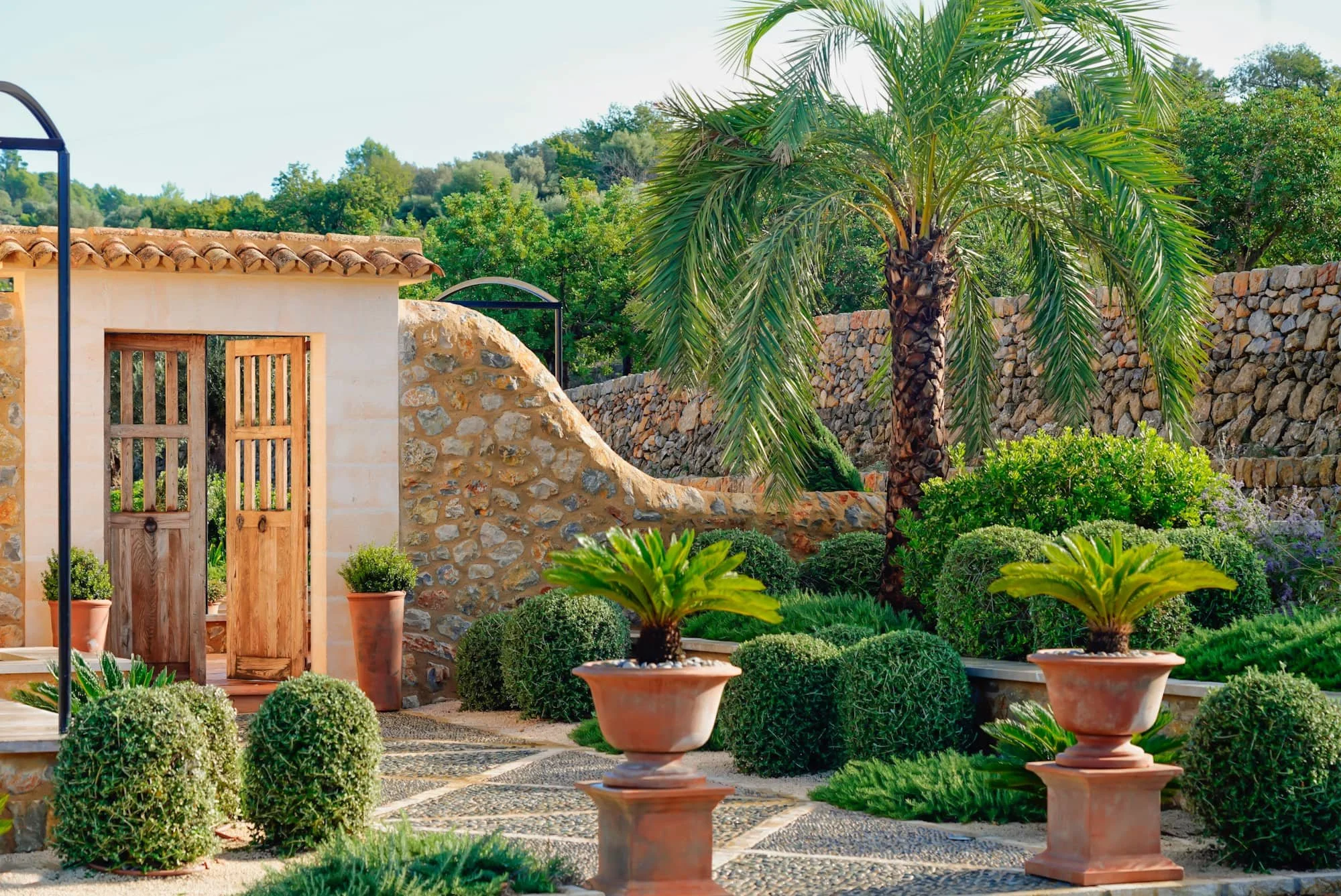 Terracotta pots flank the entrance to a finca in Mallorca, Spain.