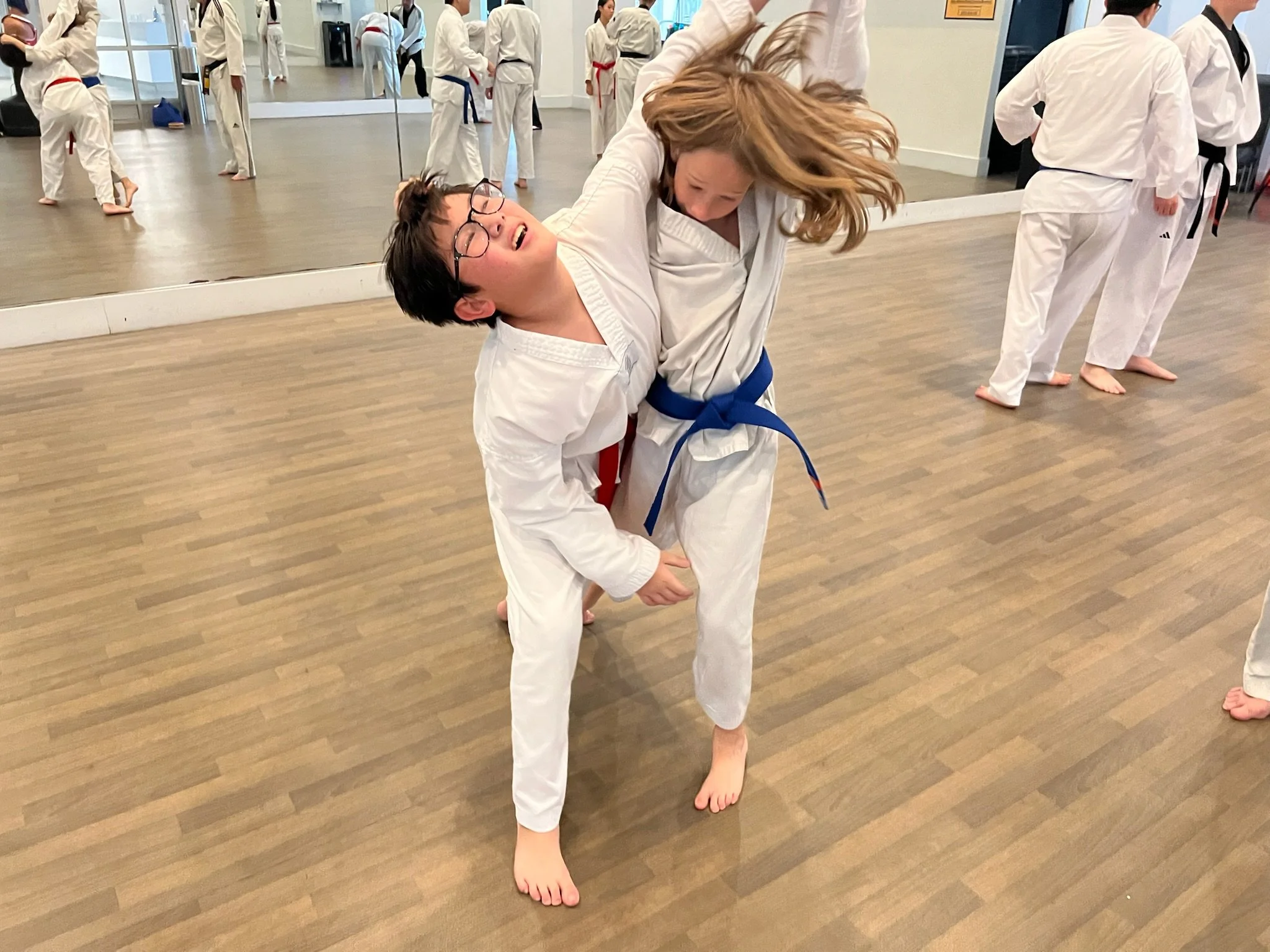 Two youth spar in class at Discovery Tae Kwon Do. 