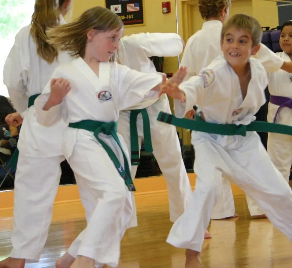 Two kids spar in class. Both green belts. 