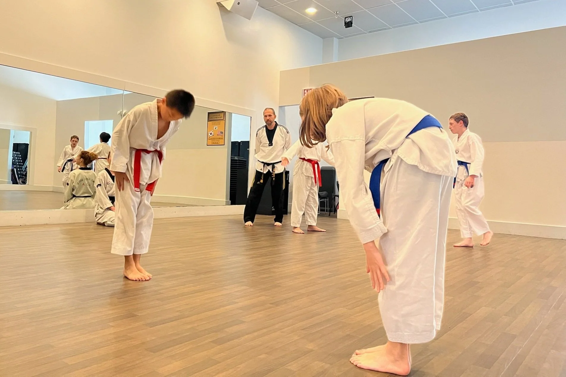 Two students bow to each other. 