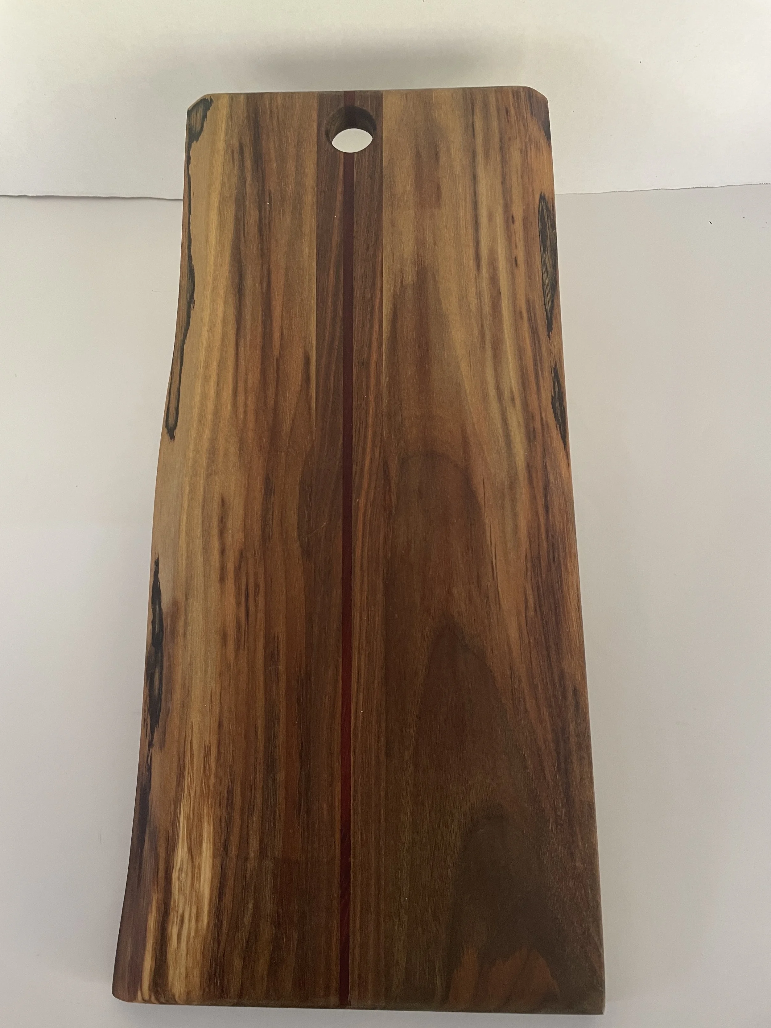 Live edge walnut charcuterie board with padauk center piece.