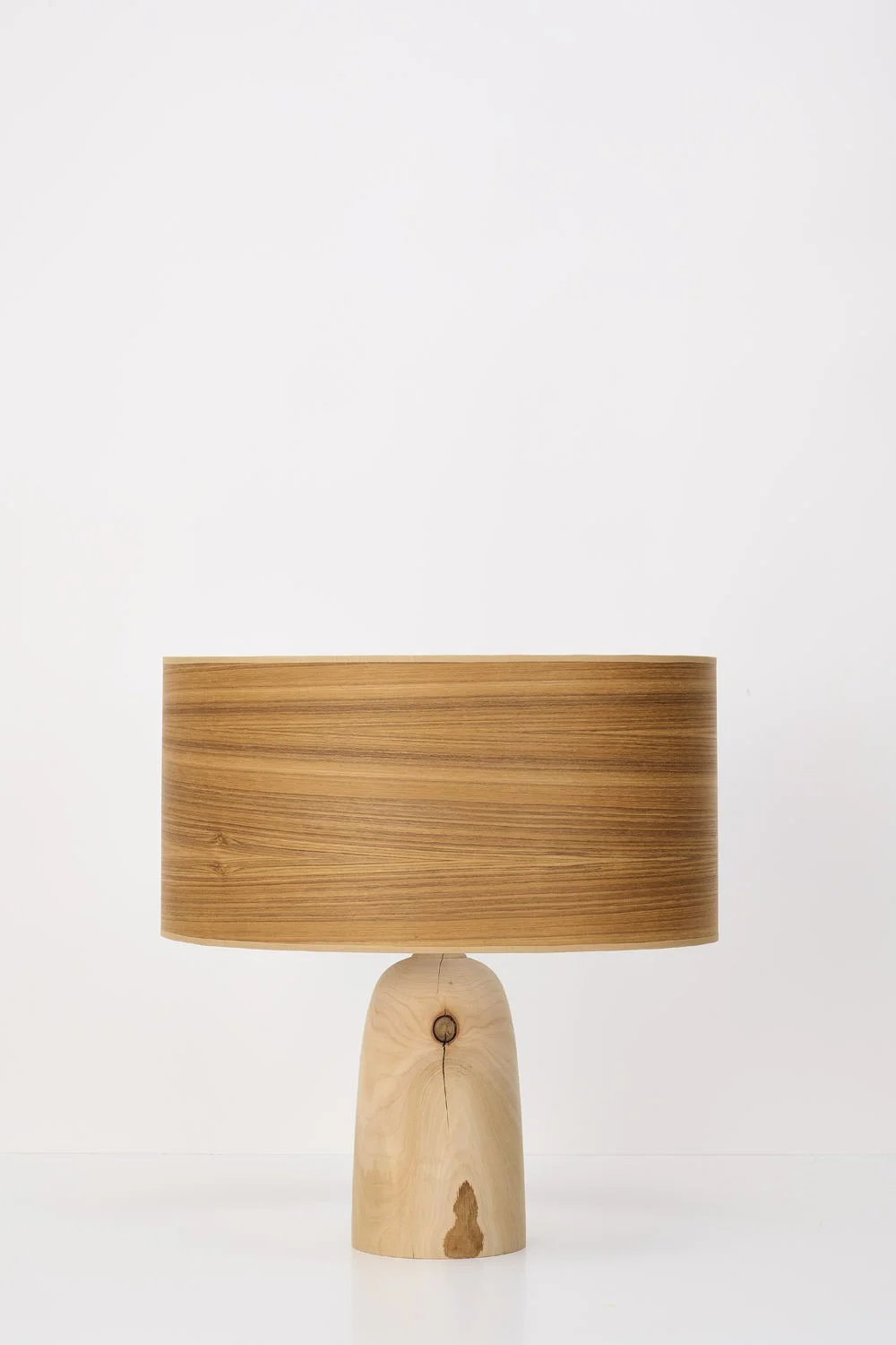 Wooden table lamp with a cylindrical shade and a natural wood base