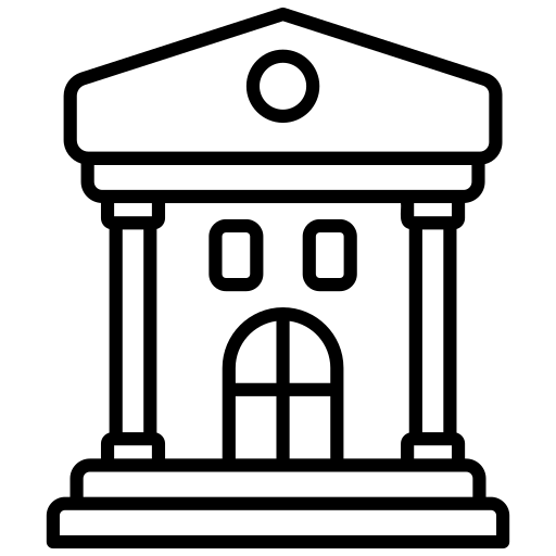 Silhouette of a person sitting on a ledge, looking out at the sunset or sunrise over the ocean or a large body of water.