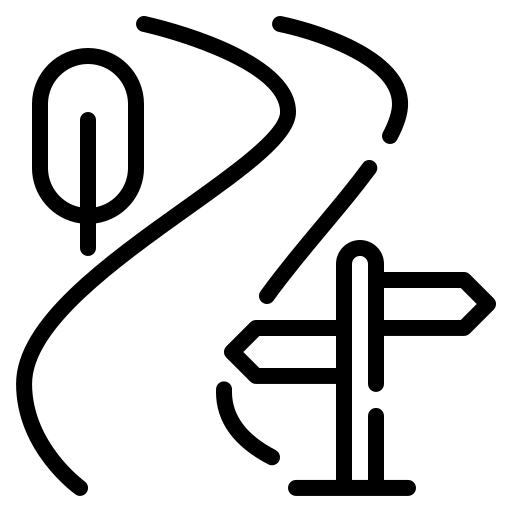 Silhouette of a person climbing a mountain at sunset or sunrise.