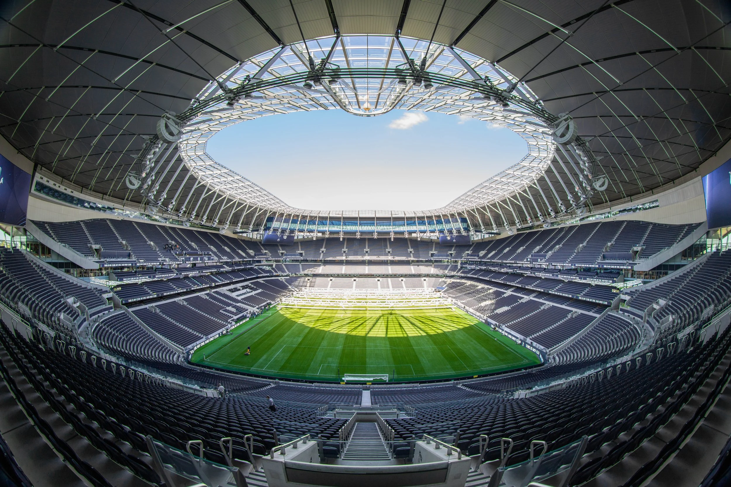 Interior view of Tottenham Hotspur Stadium seating bowl and roof, with Populous