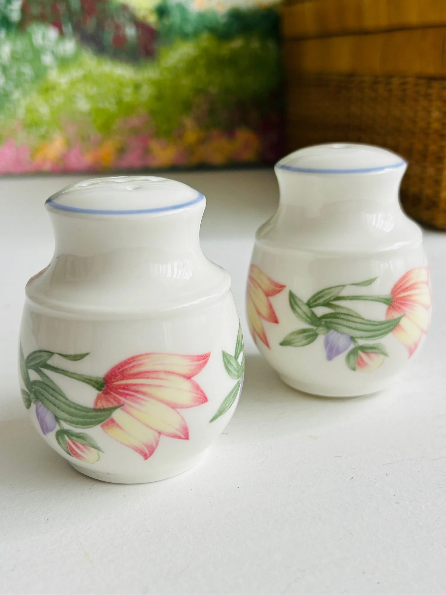 Pair of shakers shown together from a slightly different front angle, highlighting the matching form and decoration