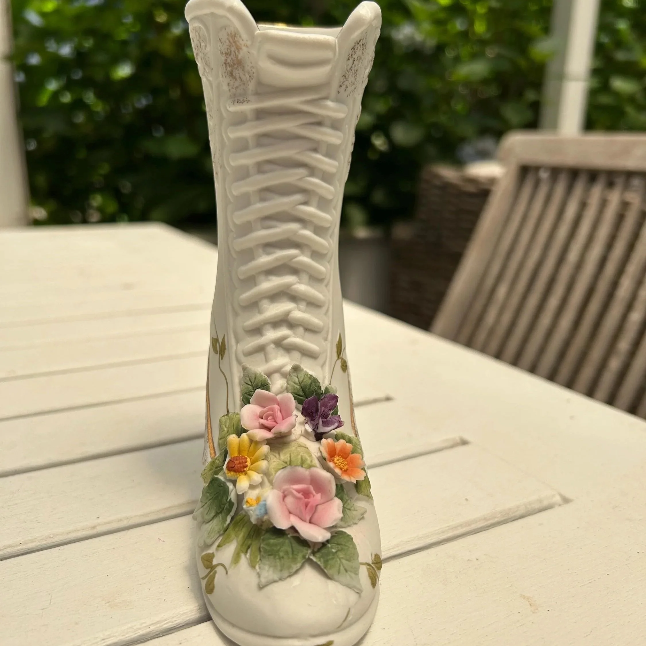 Front view showing laced boot design and raised pastel flowers