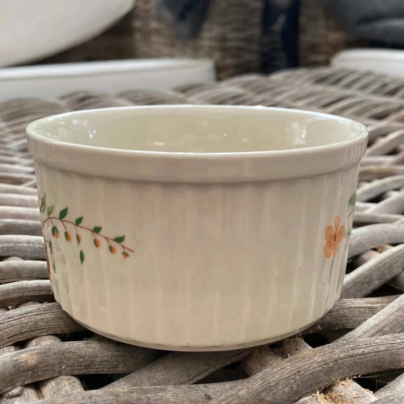 Rear view of ramekin with minimal floral accents on ribbed body