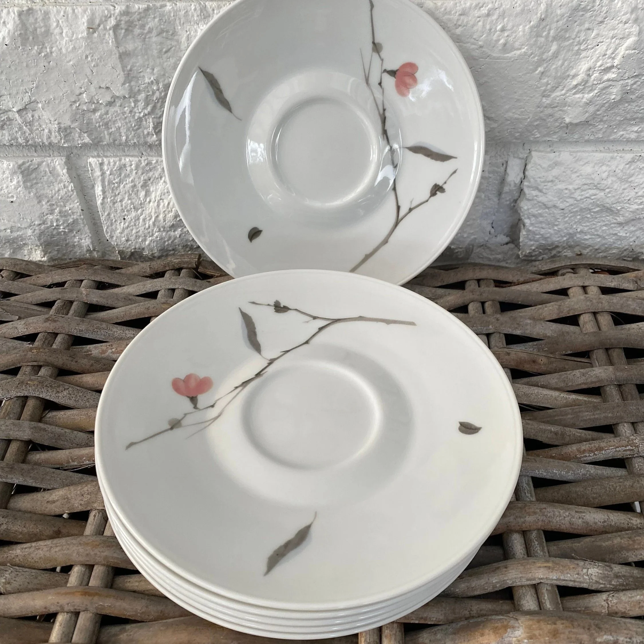 Two saucers displayed upright showing full floral design