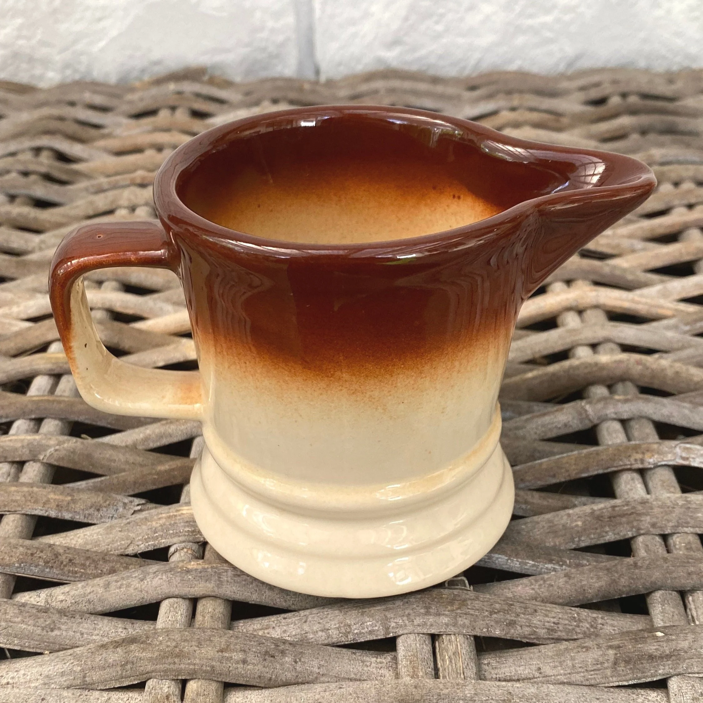 A vintage 1970s stoneware creamer with a brown & cream speckled glaze. Made in Taiwan, this small pitcher is perfect for serving cream, milk, or syrups.