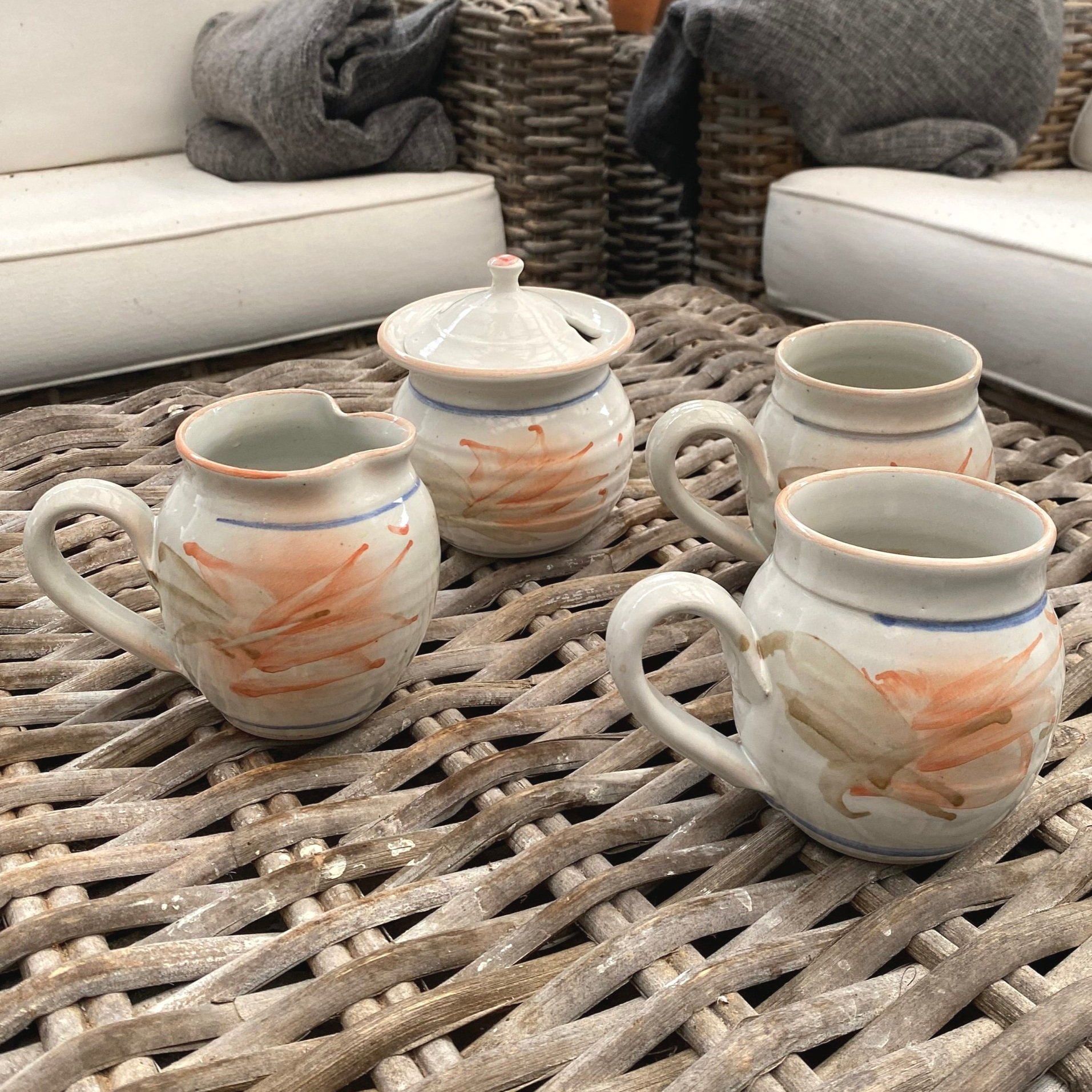 Handmade tea set by Port Curtis Pottery. Includes 2 mugs, sugar bowl, and creamer with peach floral design. Australian signed ceramic—functional and collectible.