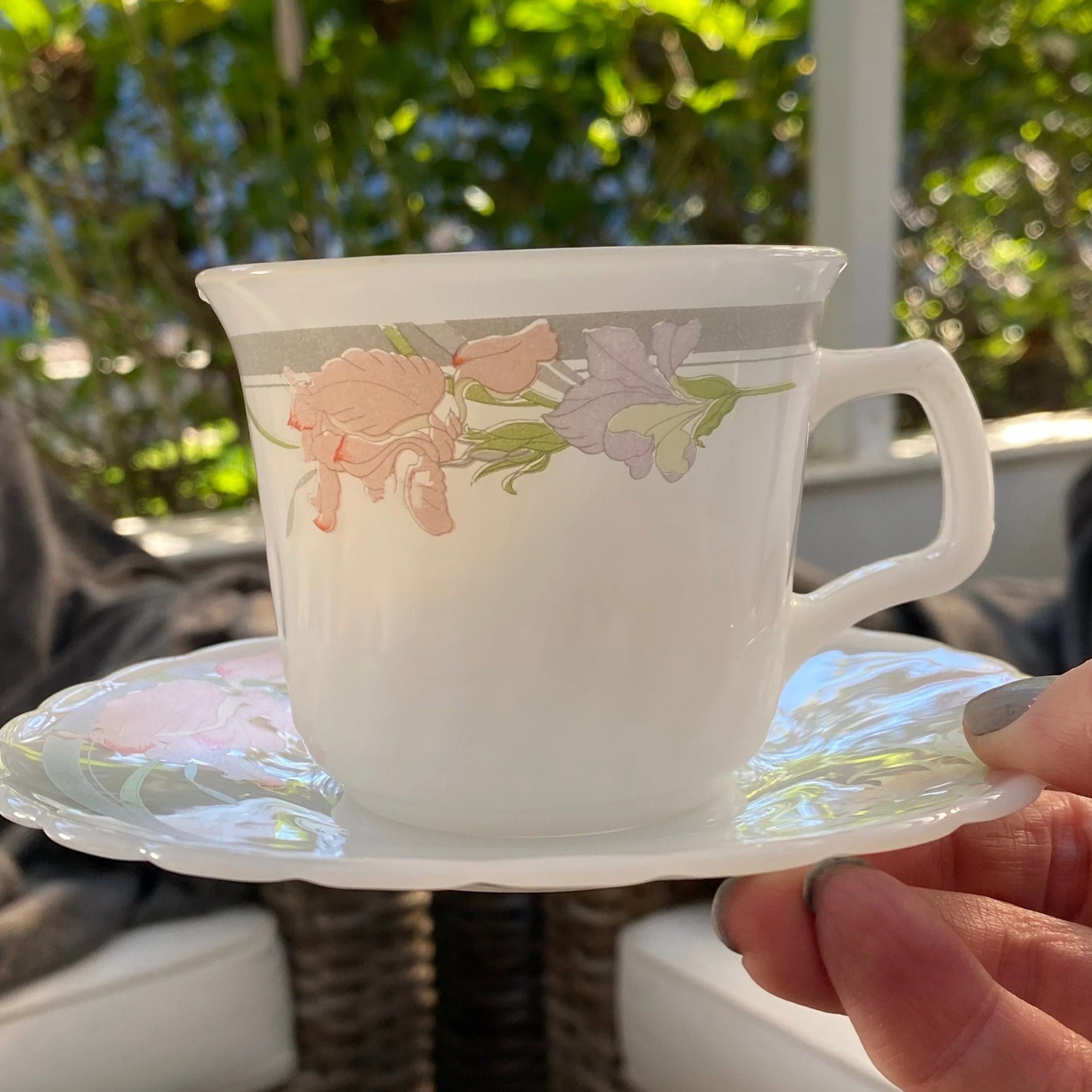 Close-up of a cup and saucer showing iris floral design