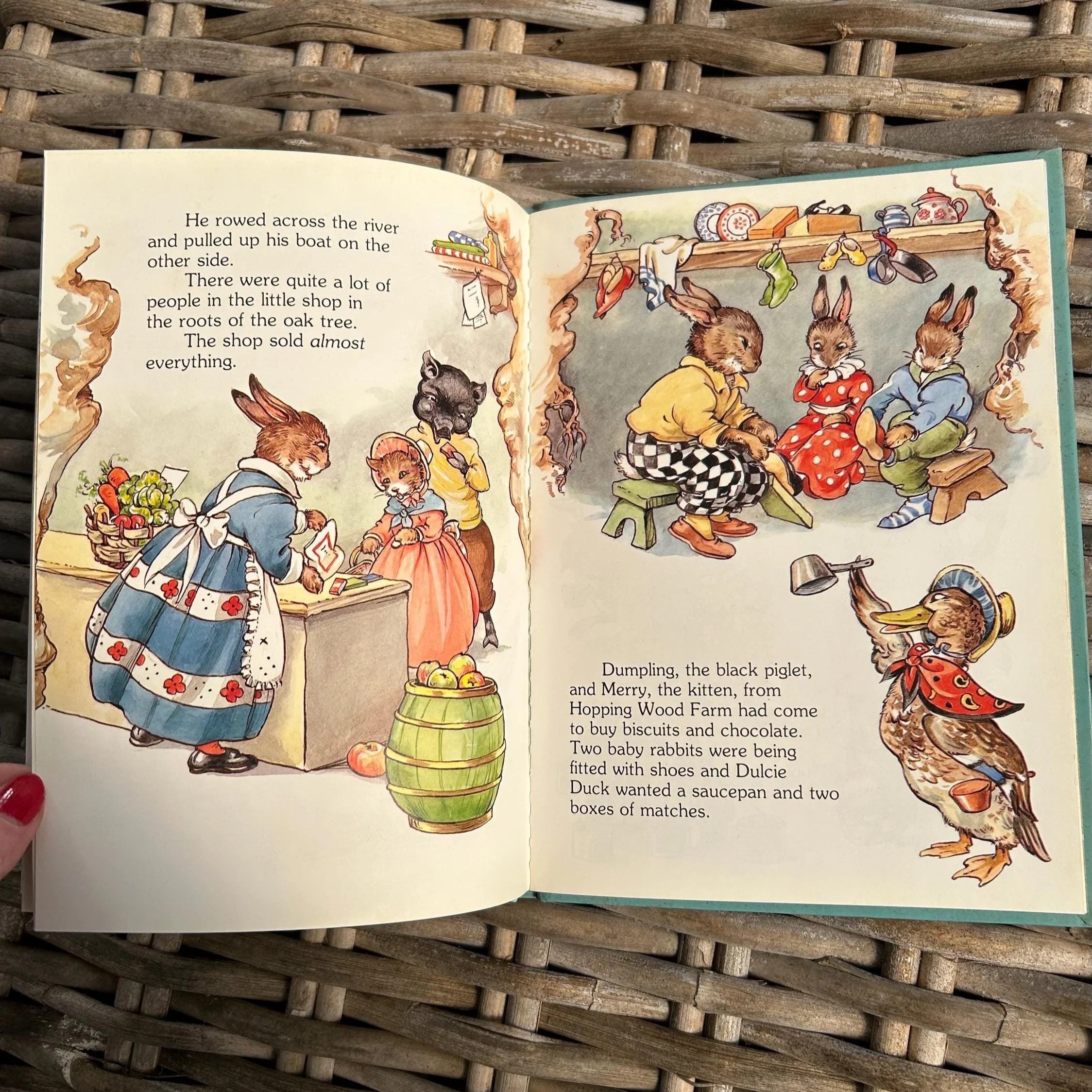 Open book showing vibrant interior illustrations of woodland scenes