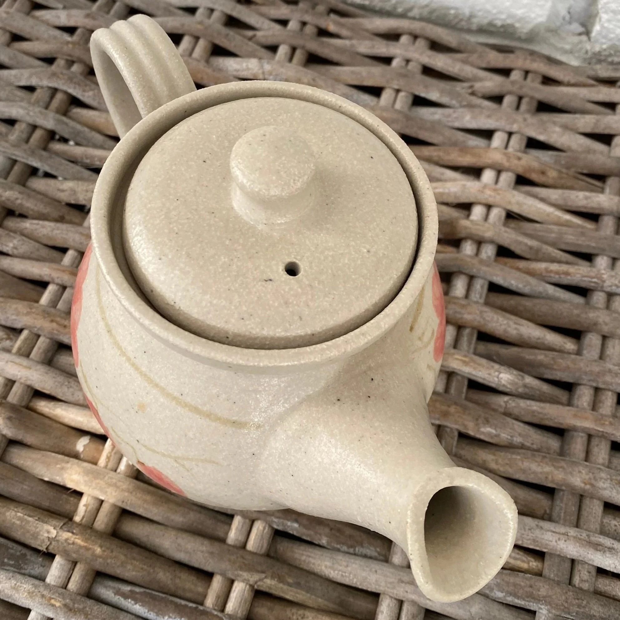 Angled overhead view of spout, lid, and top handle