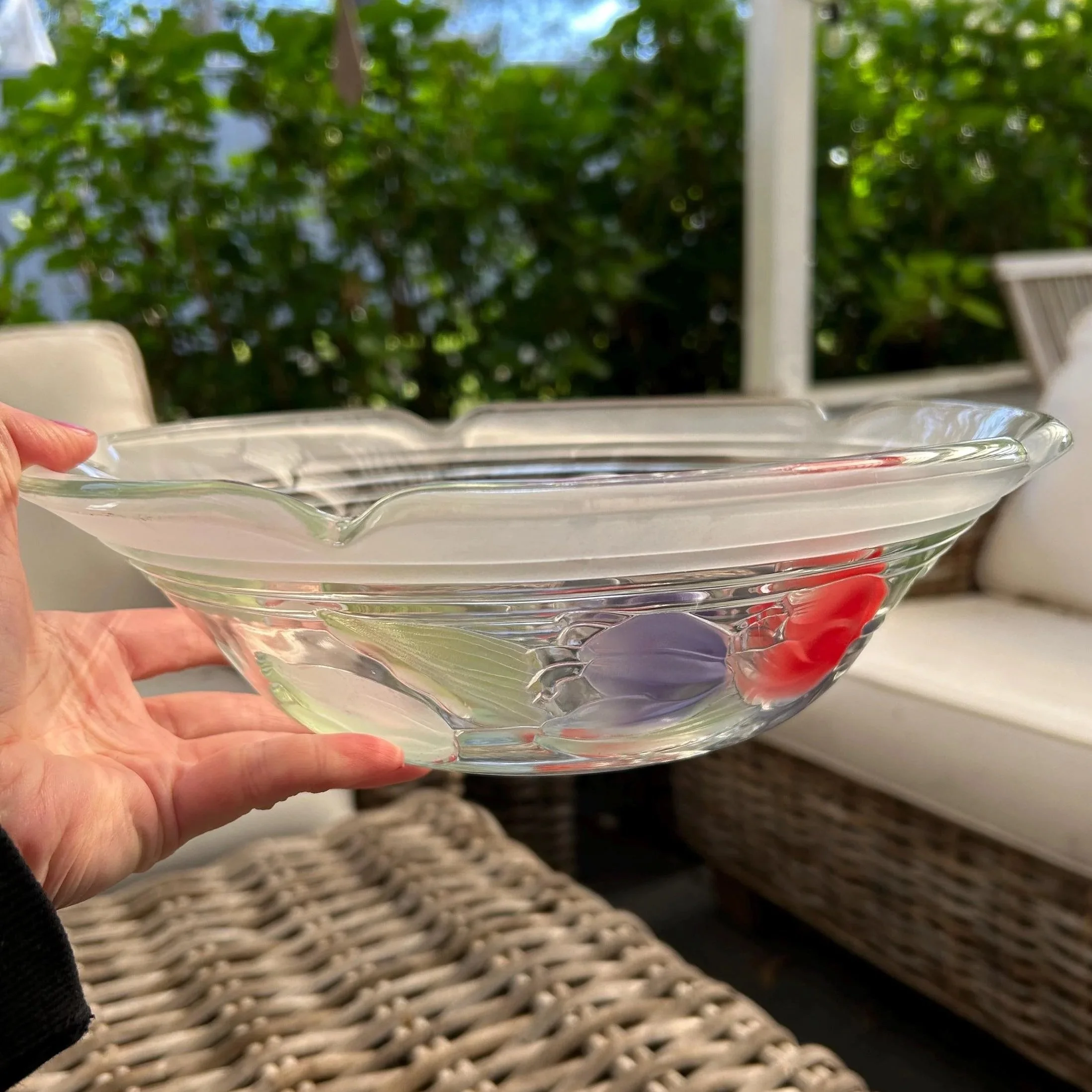 Bowl held sideways showing transparency and floral detail