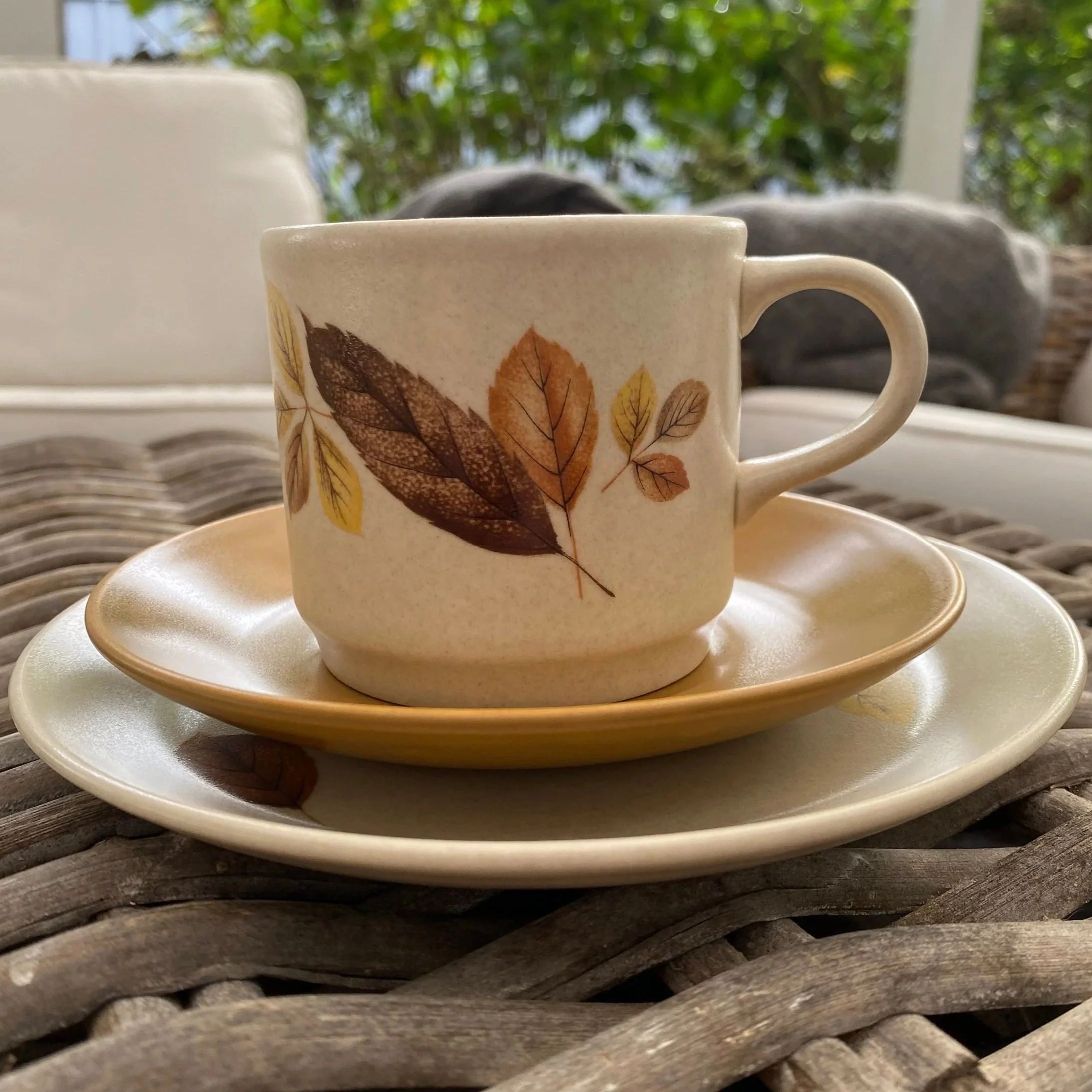 Close-up of a trio from side showing autumn leaf design