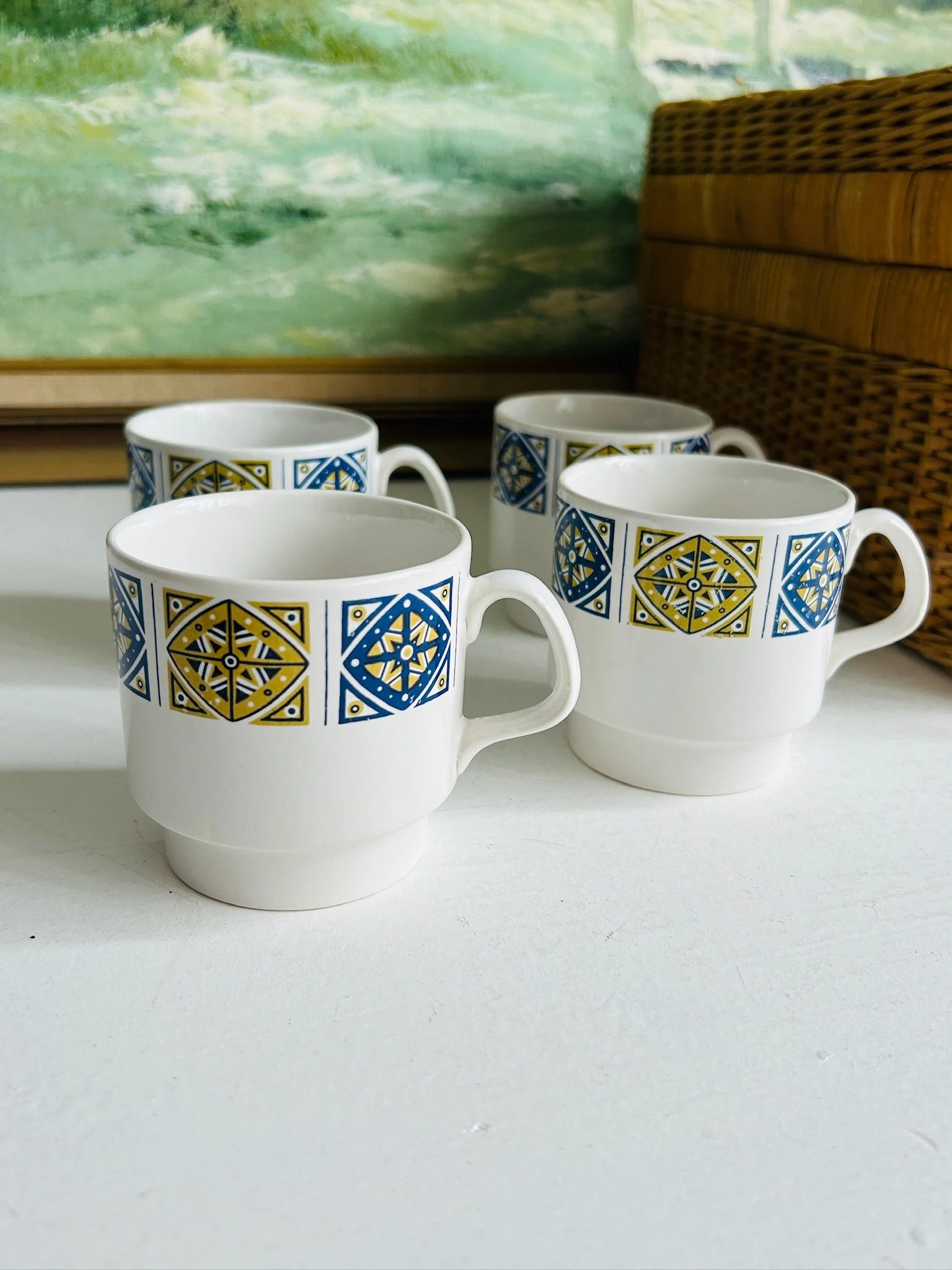 Alternate group view of the four matching Staffordshire Midas cups showing uniform pattern placement.