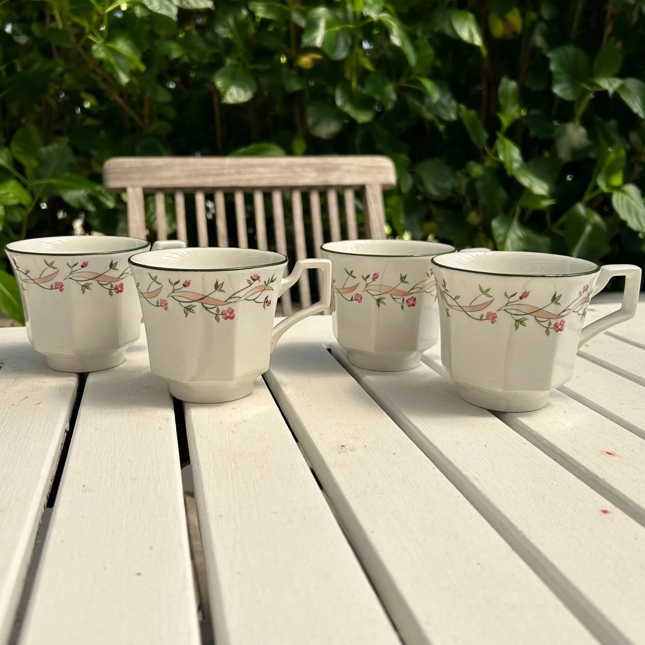 Full set of four Eternal Beau cups arranged on white table