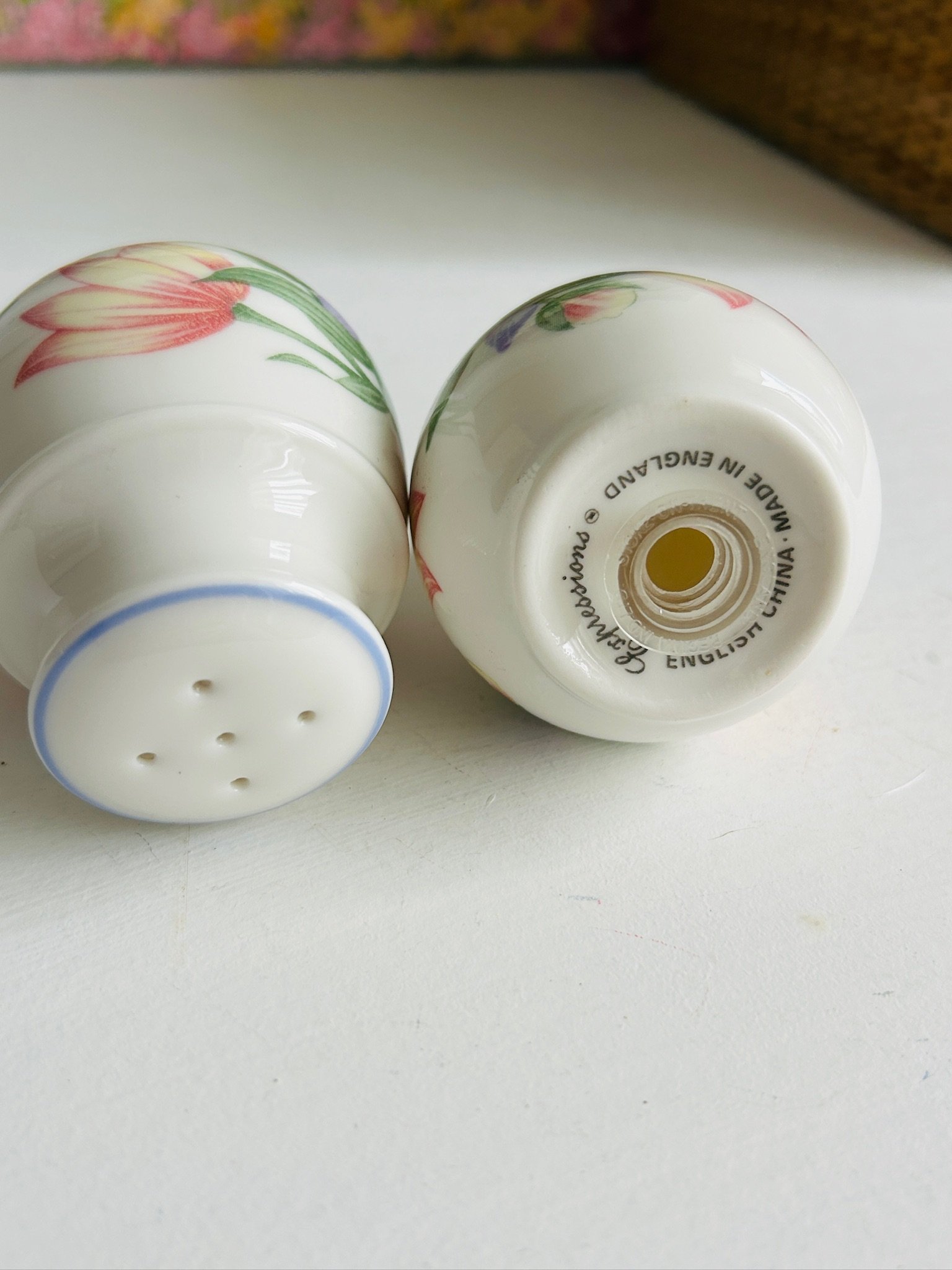 Shakers lying on their sides with one underside visible, showing the backstamp and shaker holes in the current photo order