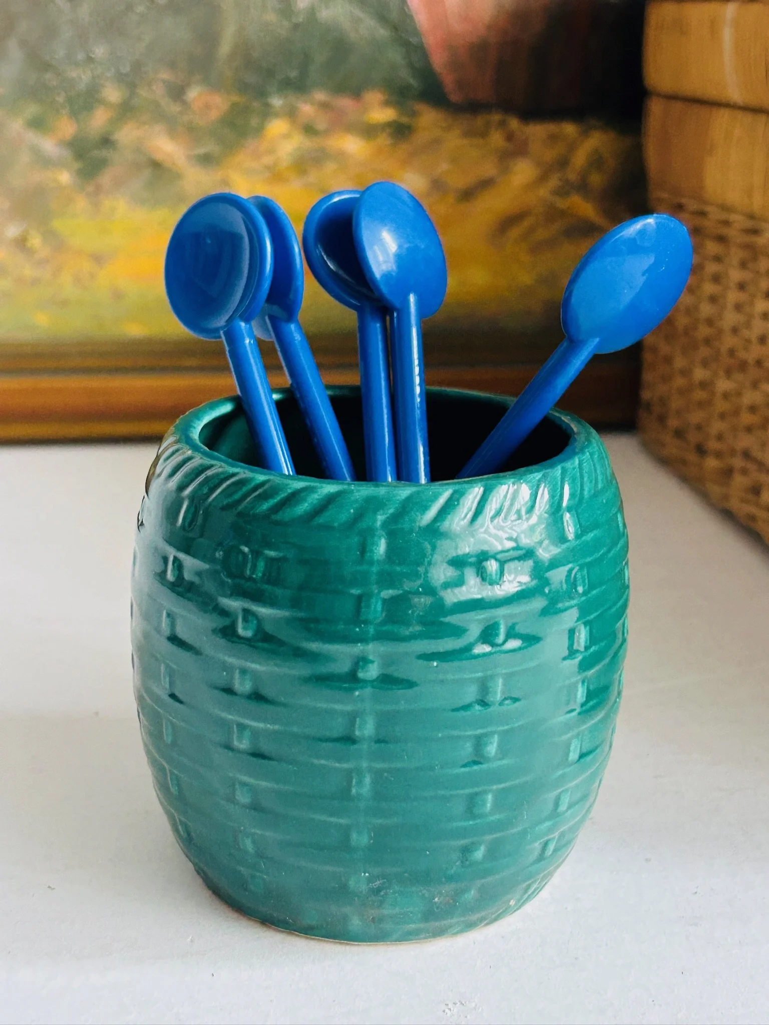 Set of blue Bodum stir spoons arranged in a turquoise cup, styled as a retro coffee station accessory