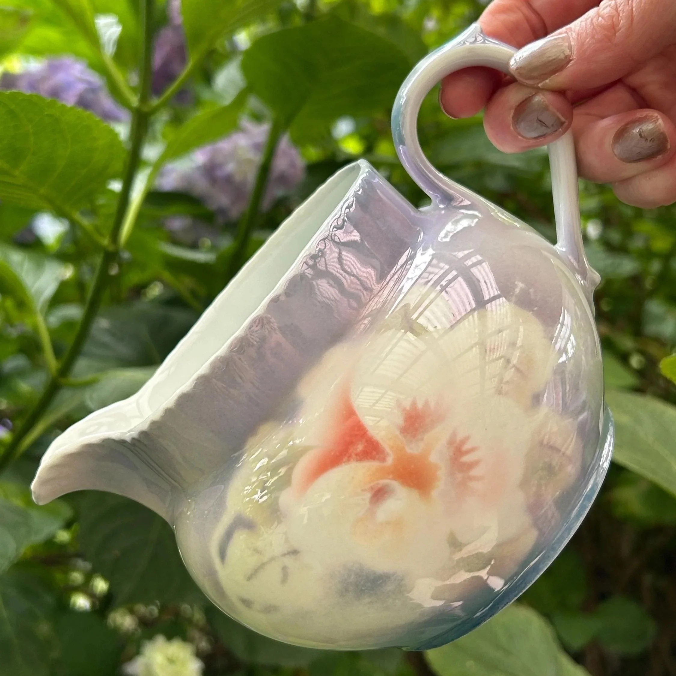 Side angle of spout and handle showing delicate lavender tones and glaze texture