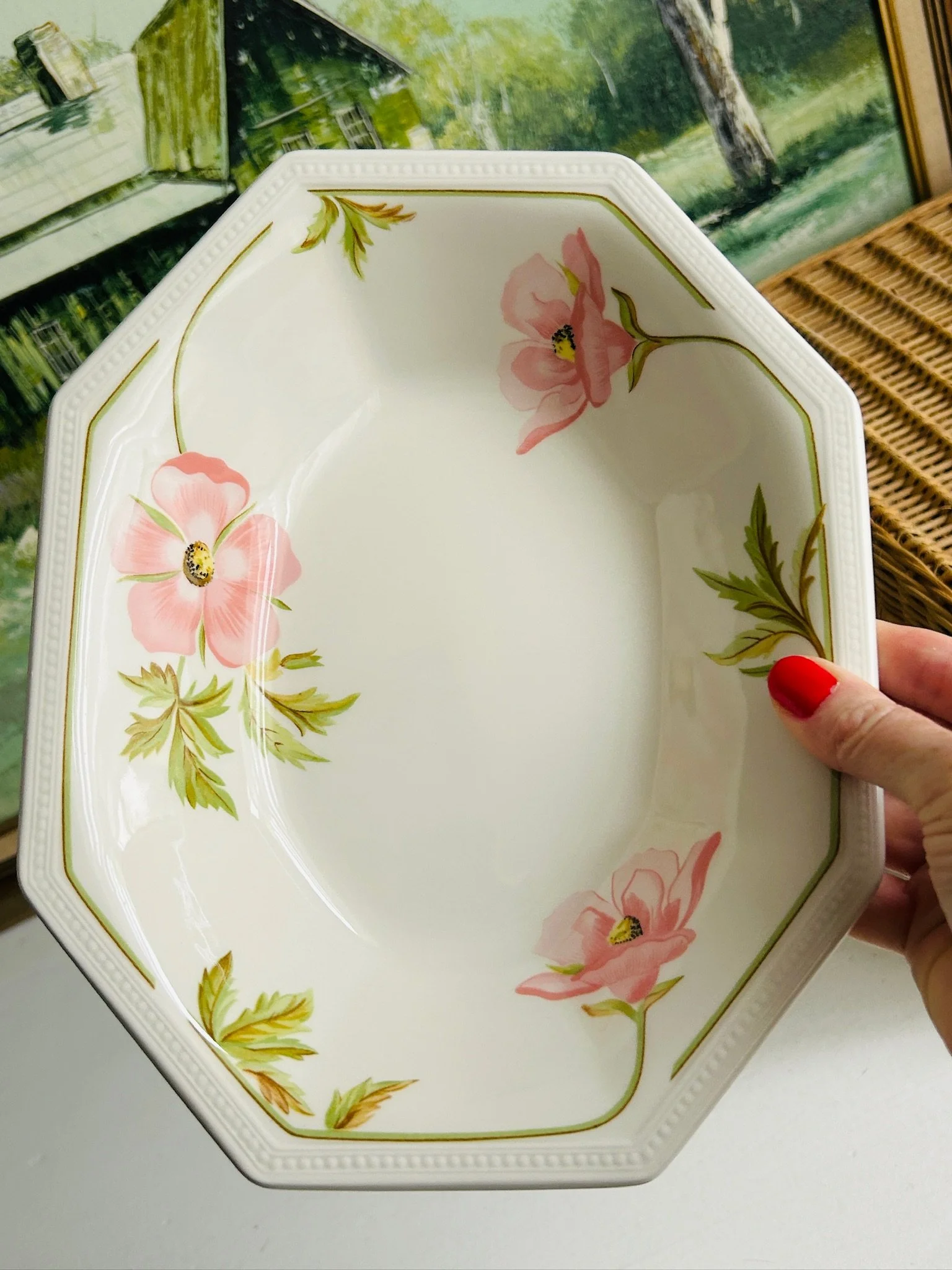 Top view of a single Johnson Brothers Spring Morning bowl held in hand, showing the full floral arrangement inside the bowl.