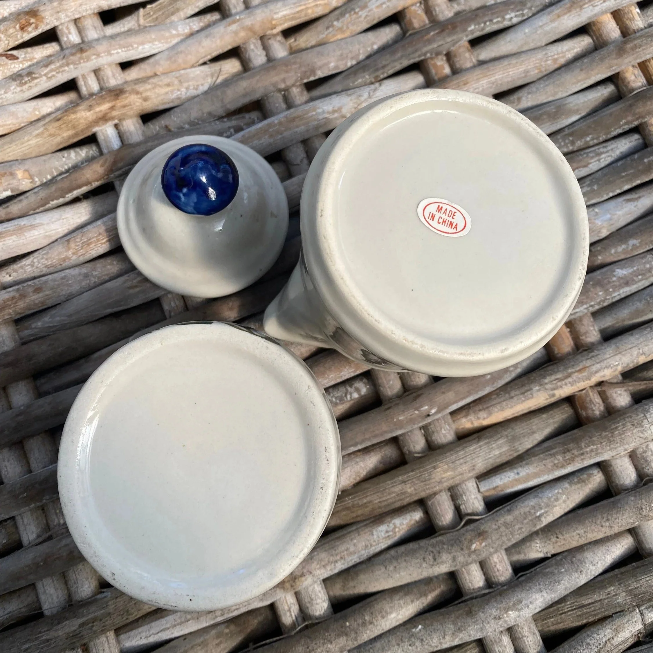 Bases of both items showing glaze finish and sticker markings