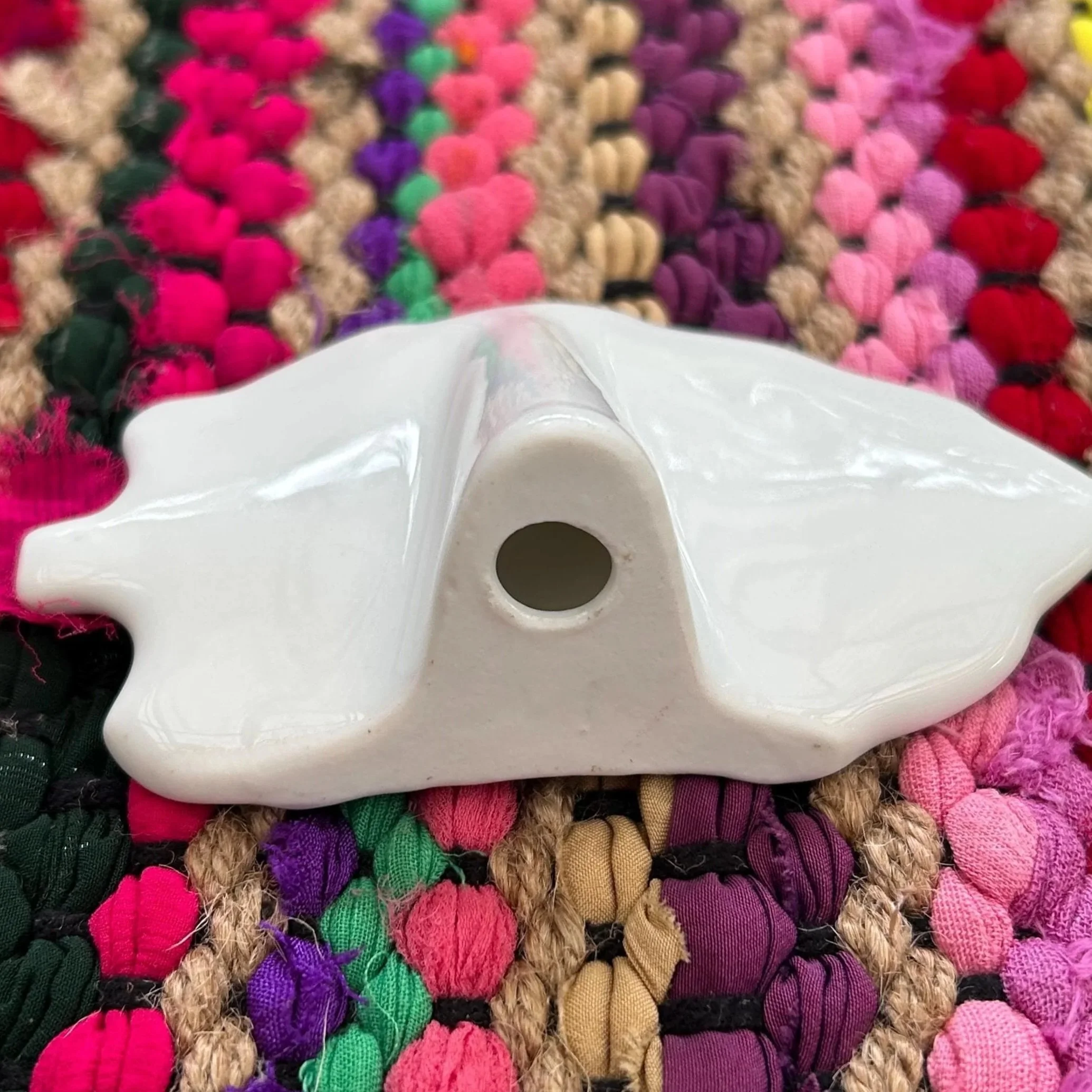 Underside view showing scalloped form and raised foot with central hole