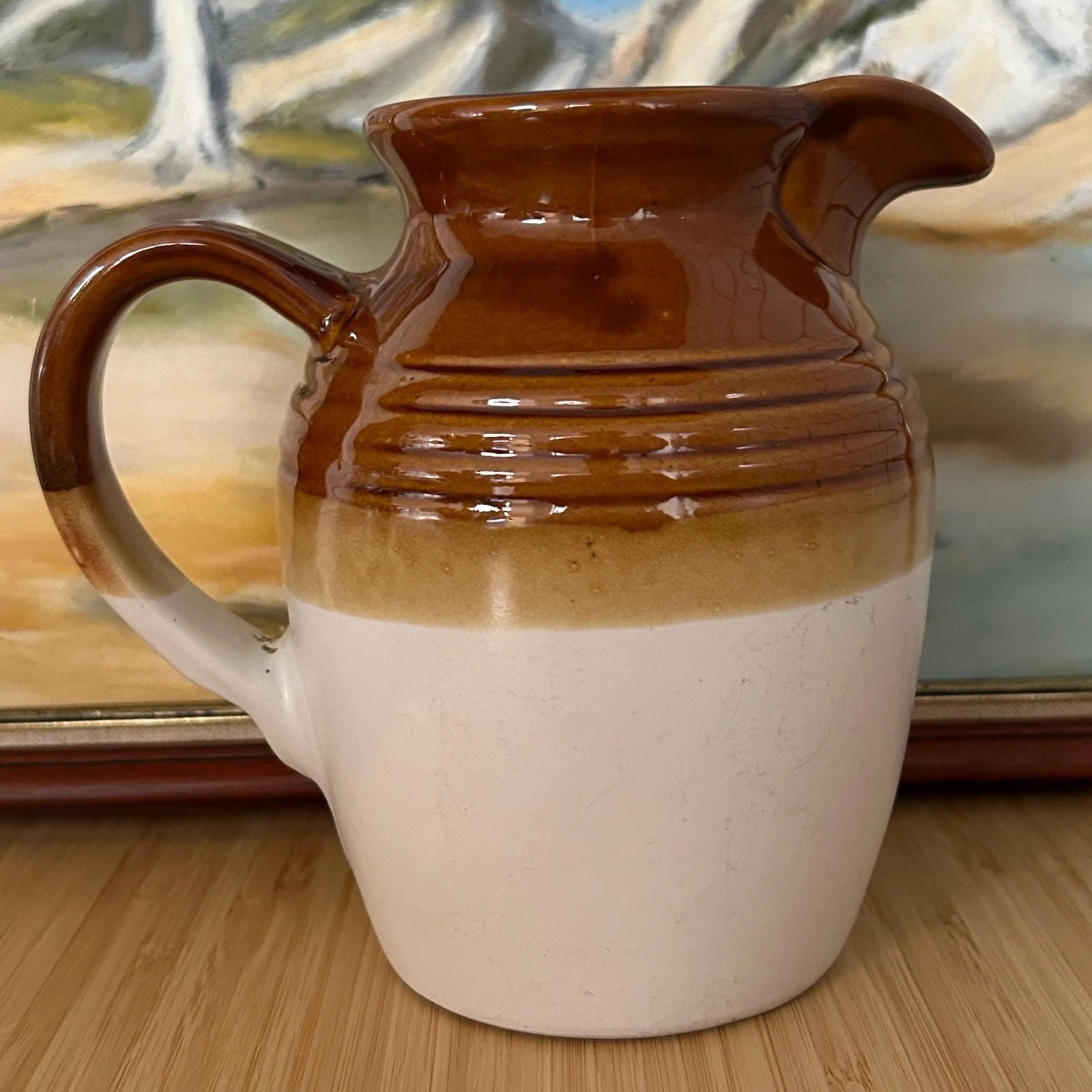 Close-up of ribbed vintage pitcher showing curved handle and colour gradient