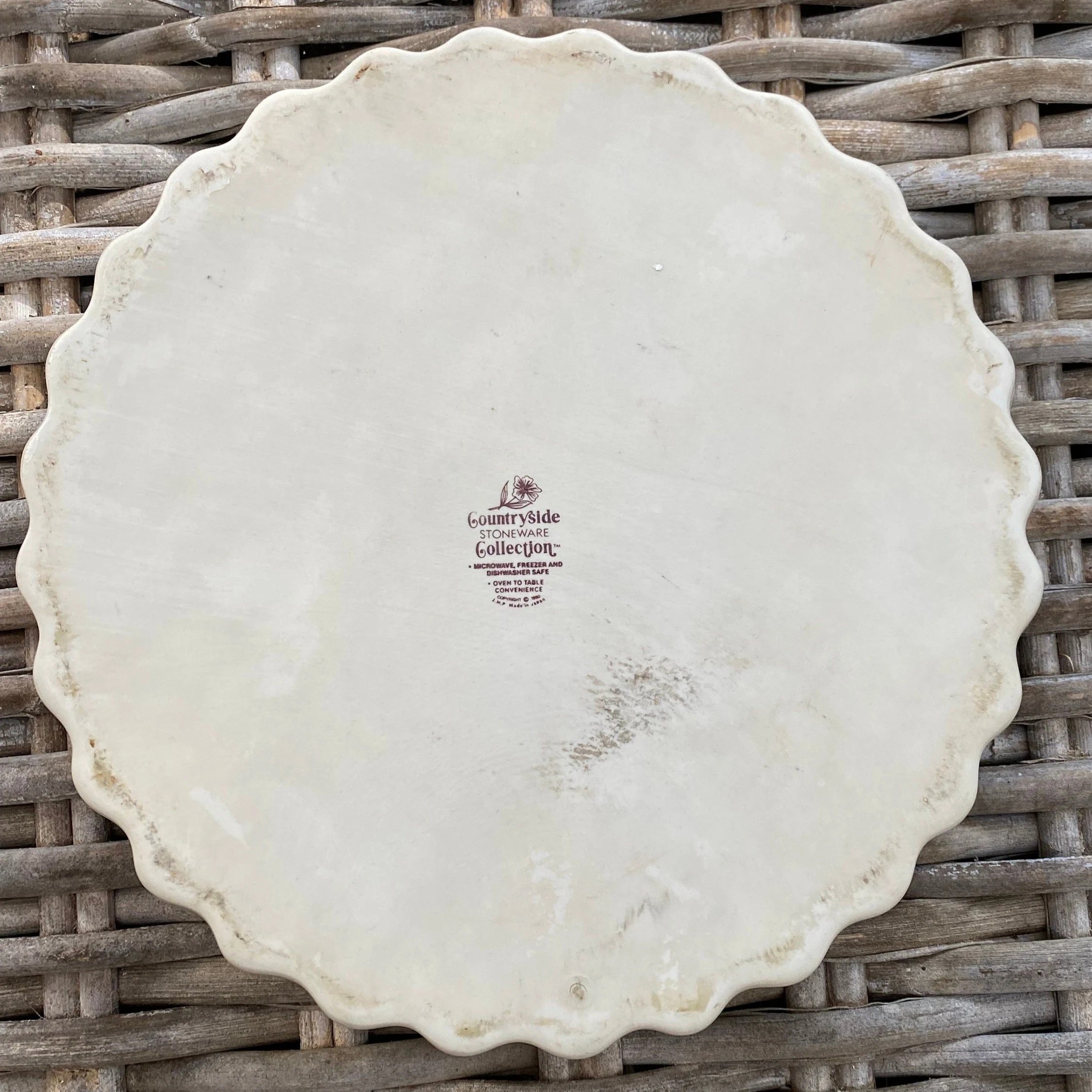 Underside of dish showing unglazed base and central stamp